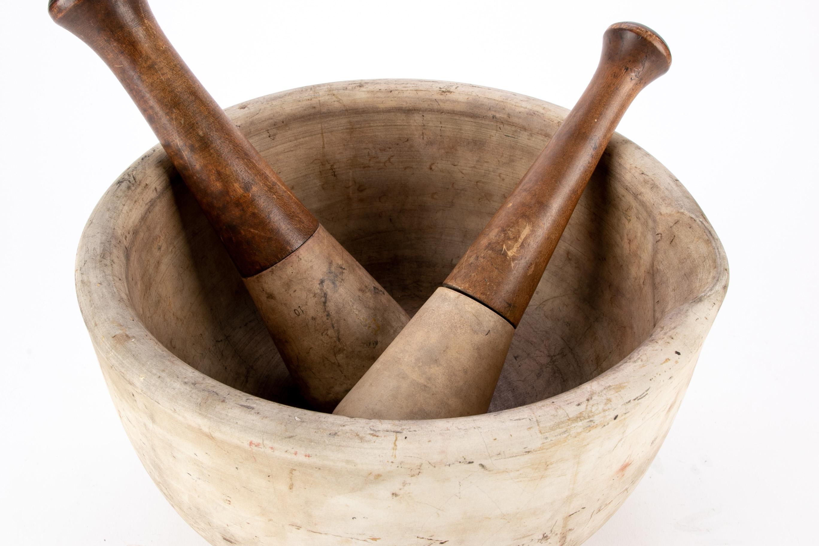 Large scale antique heavy ceramic mortar and two pestles along with two wooden handled ceramic pestles. Larger pestle L. 11 1/2
