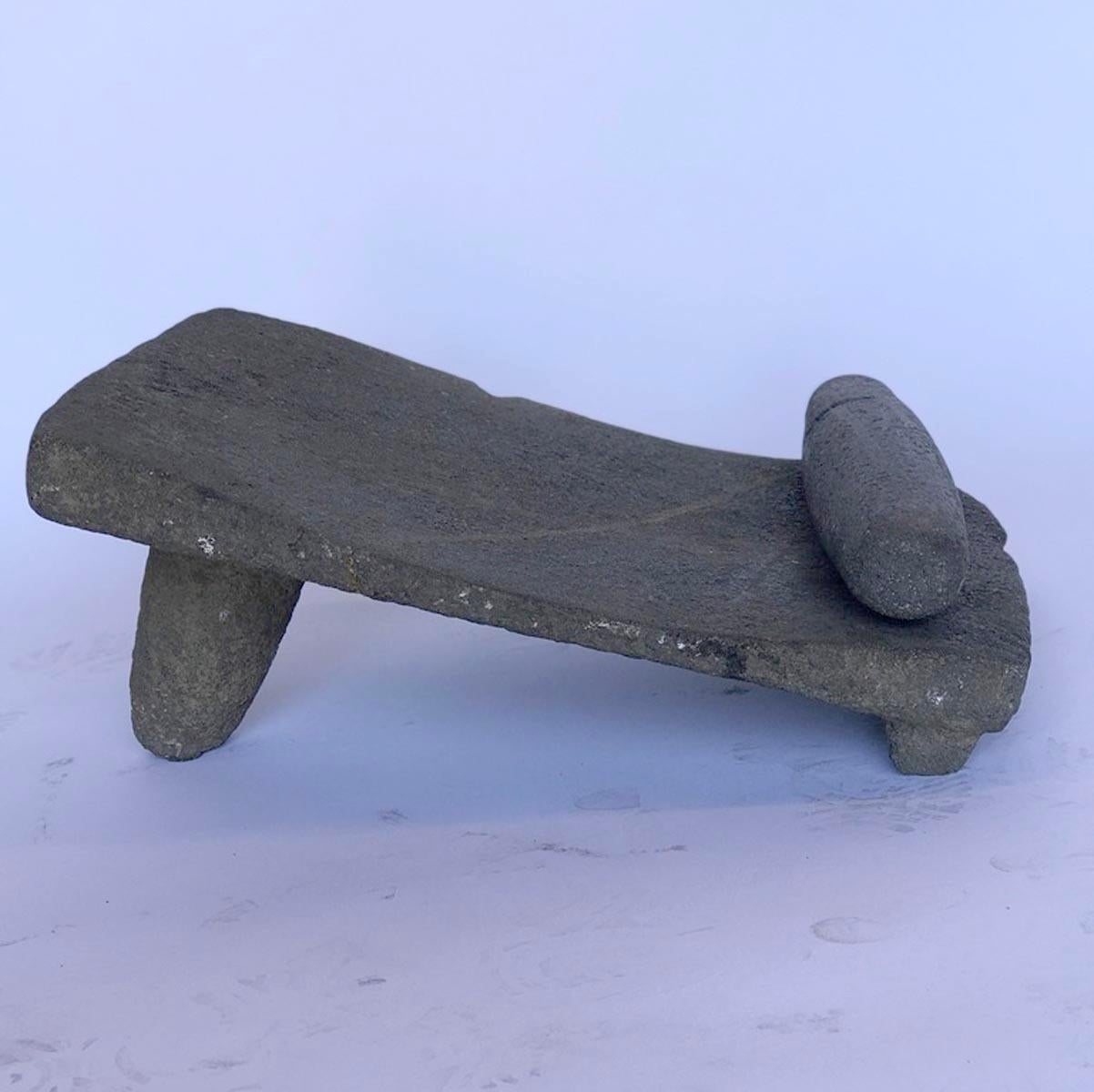Early 20th century Guatemalan stone matate, or piedra de moler - grinding stone. Carved from one piece of stone, usually volcanic rock. Used for grinding corn and seeds. Comes with the grinder. Both base and roller have old repairs.