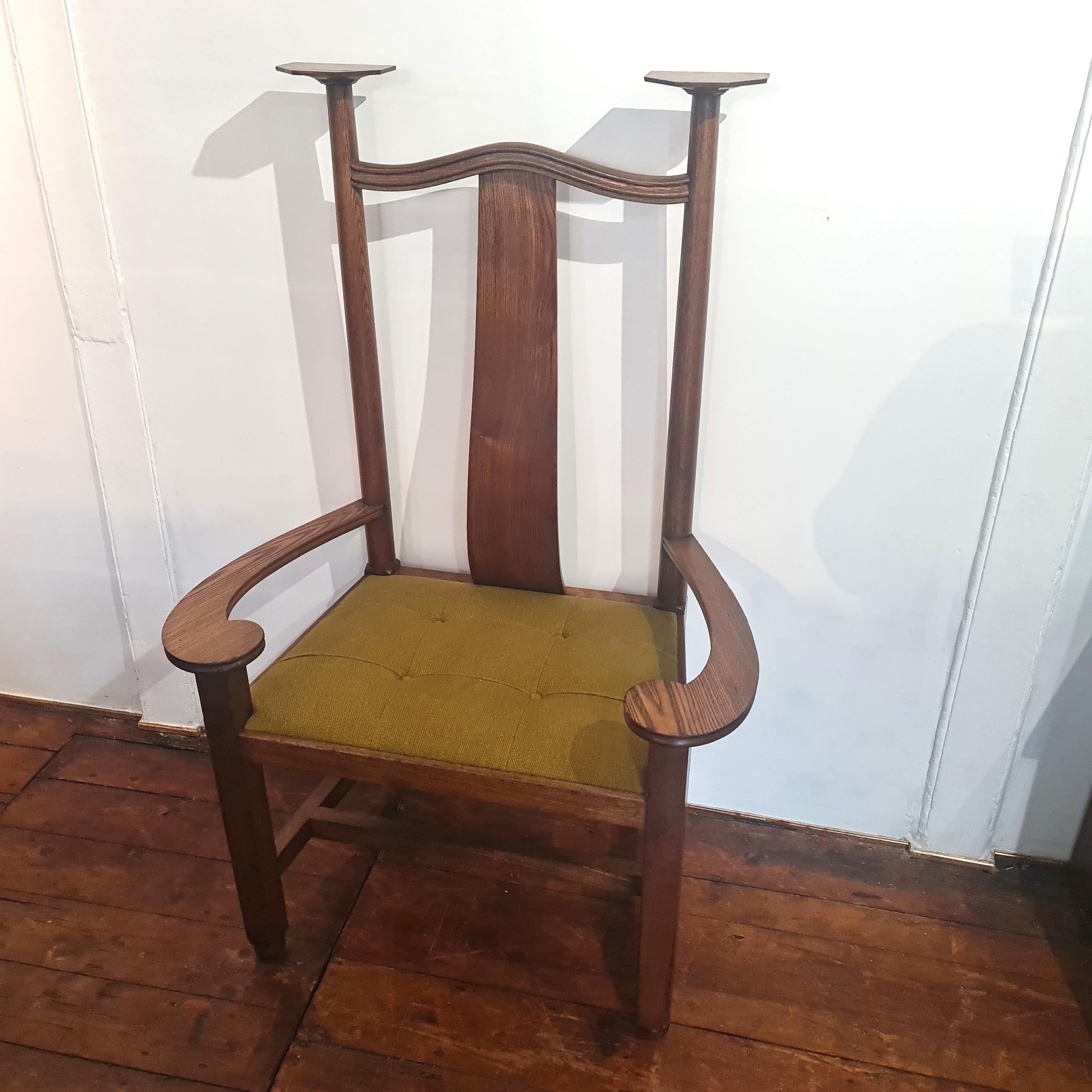 Large scale Arts & Crafts oak armchair. This dramatic armchair with its sweeping arms and capped uprights was made circa 1900.   