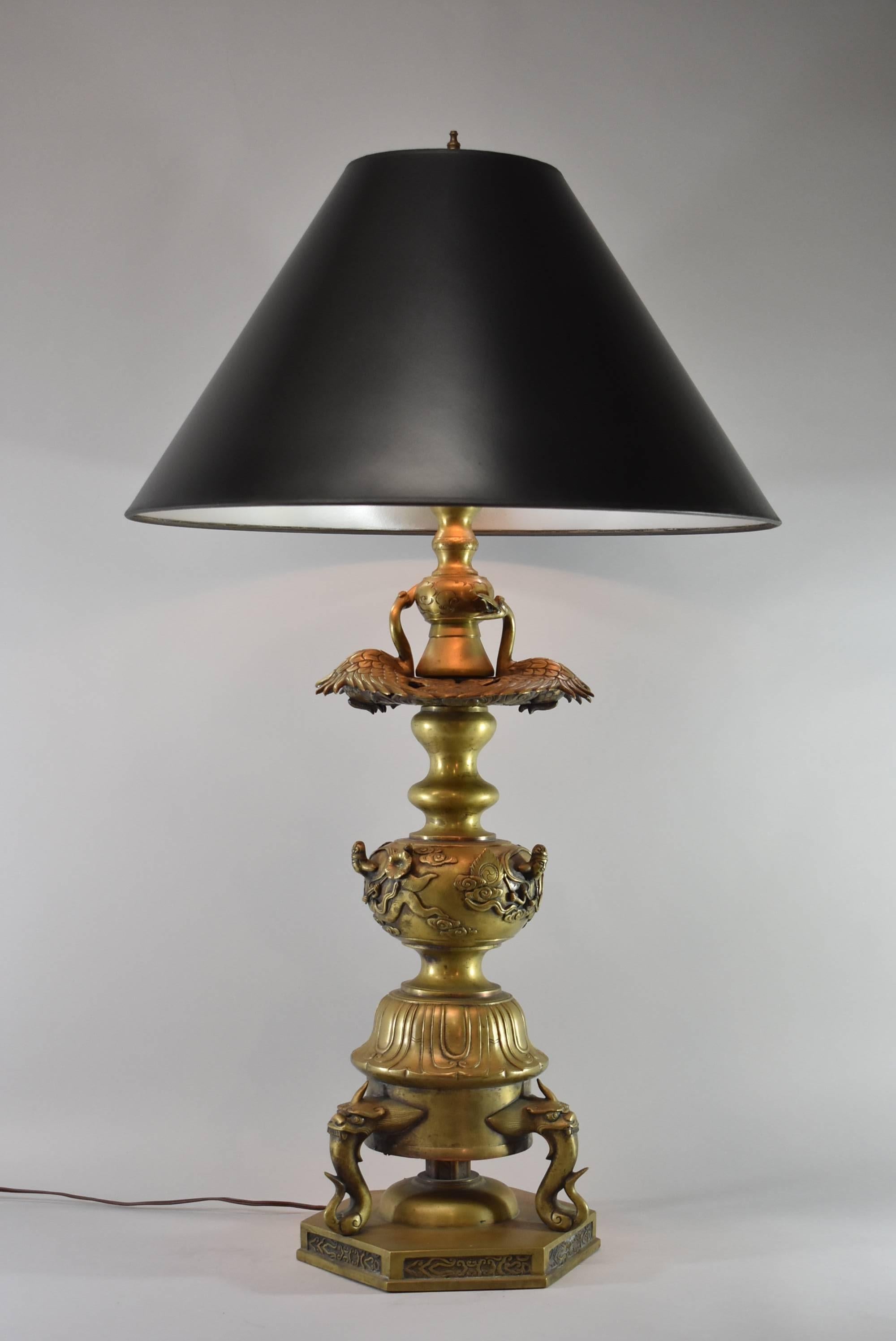 A stunning Asian style brass lamp. This large-scale lamp features cranes, dragons and female figures. Sure to make a statement in any room. The dimensions are 42