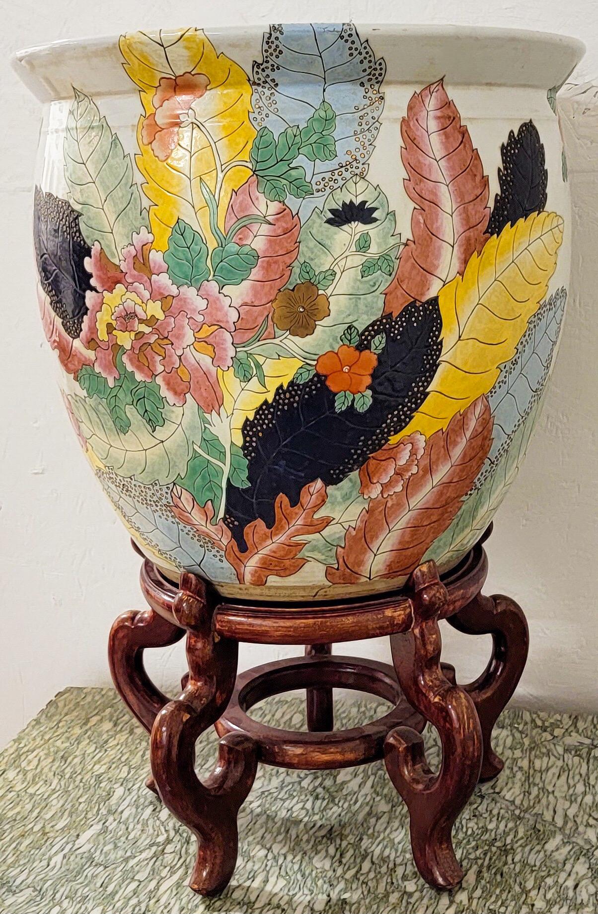 I love this! It is a large scale Asian planter with a vibrant tobacco leaf pattern. It is in very good condition. The planter height is 16”. The stand adds another 10”.