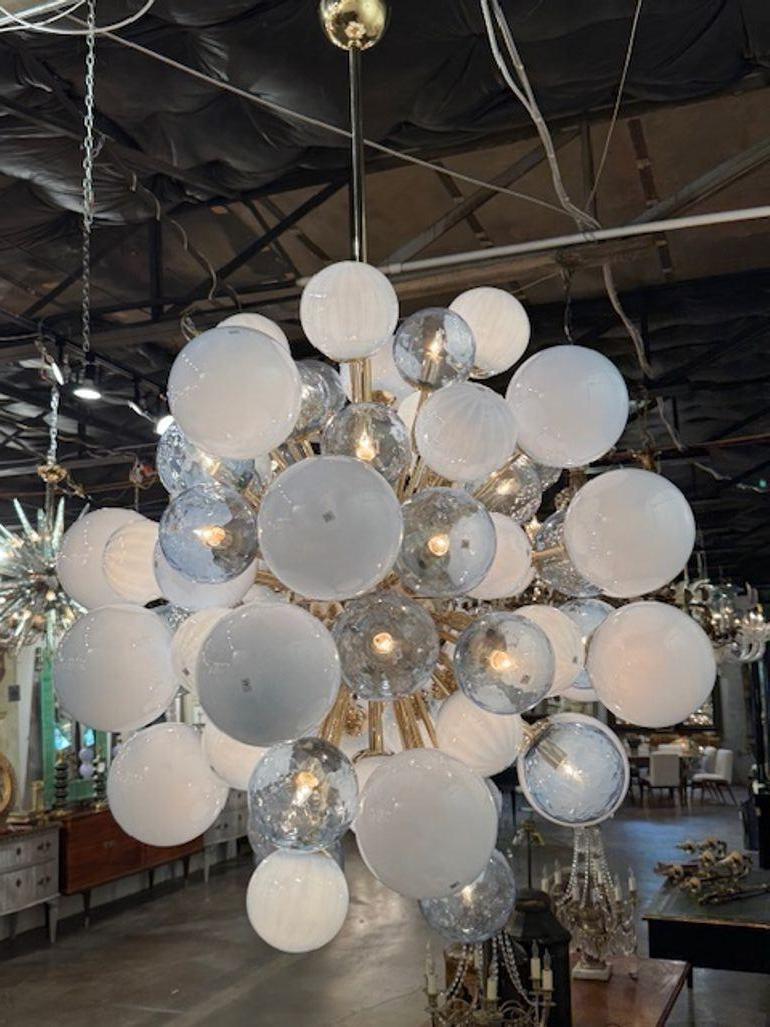 The Large Scale Blue Murano Glass and Brass Cloud Chandelier is a stunning and elegant lighting fixture for any home or garden. The sputnik cloud design adds a unique and artistic flair, making it a standout piece in any room. The large scale of