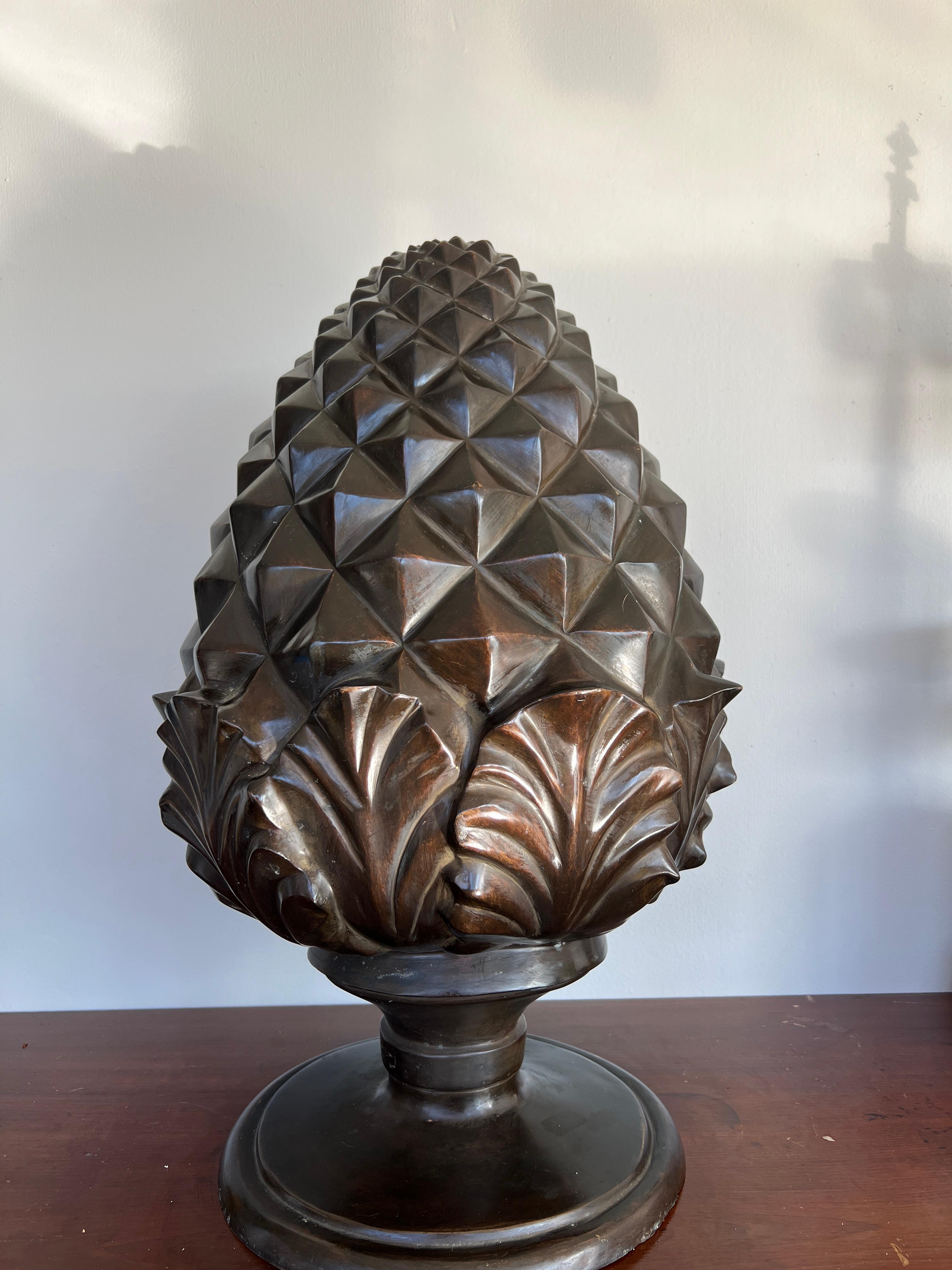 A large scale bronze model of a pinecone or pineapple. The piece has acanthus leaf sprouts and solid pyramid form spikes to body. Likely produced in the 1980's. 

23