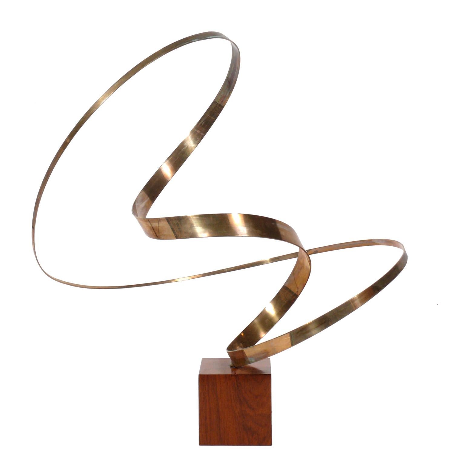 Large scale bronze kinetic sculpture, attributed to Jose de Rivera, unsigned, American, circa 1970s. It is constructed of bronze on a motorized walnut base. It measures an impressive 32