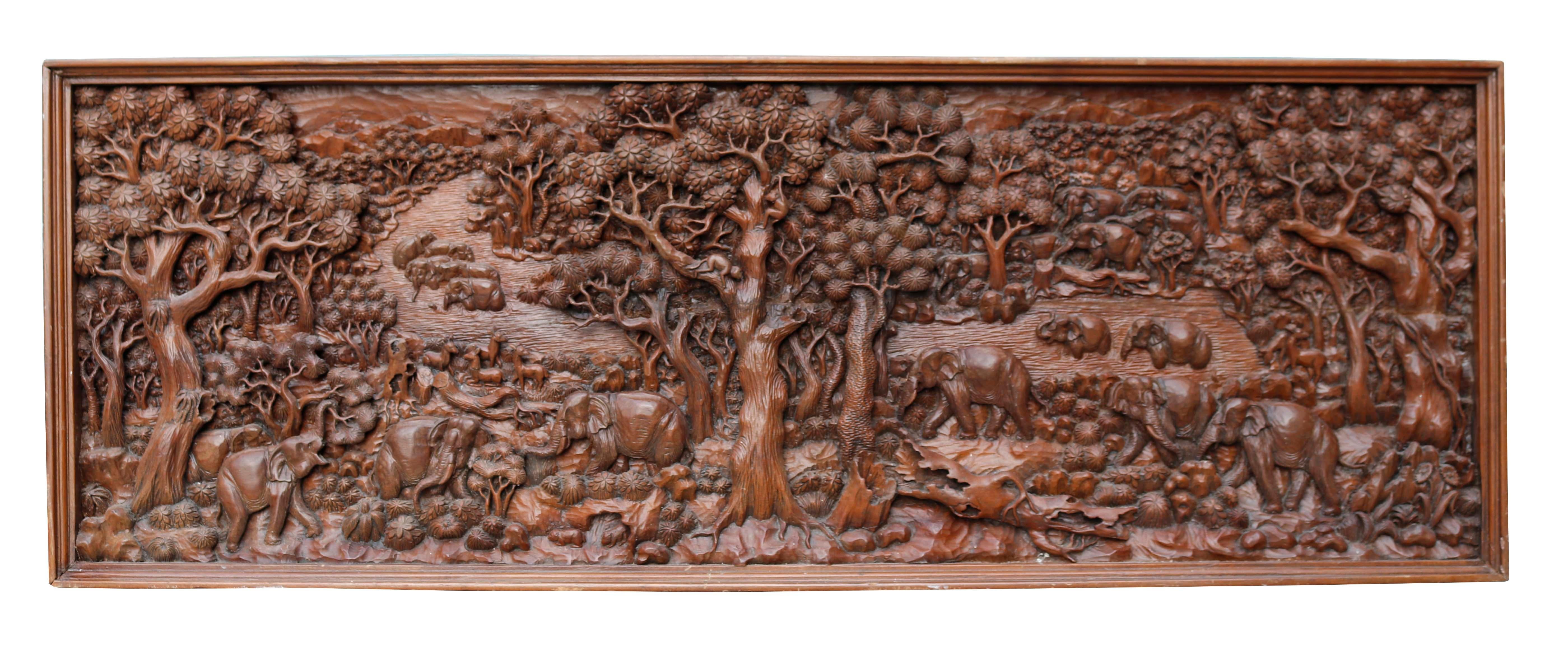 Large carved oriental wall panel. Originating in Thailand, this piece was imported to the UK by its previous owner in the 1950s. The panel depicts a jungle scene of flora and fauna. The rich colour of the wood brilliantly compliments the detail of