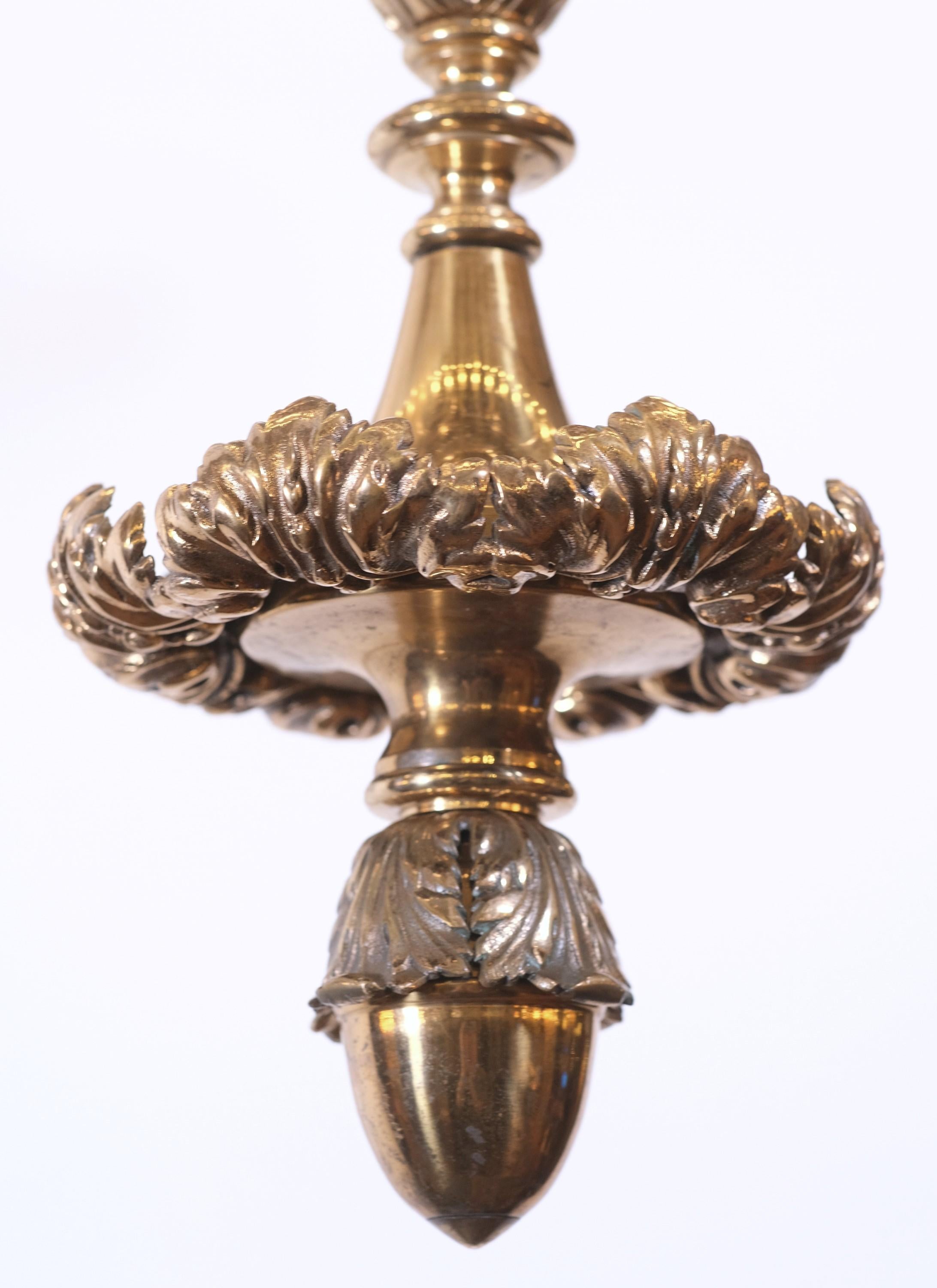 Large scale early 20th century Beaux Arts design lobby chandelier. Polished bronze with finely cast details. Takes 48 standard medium base E26 light bulbs. Cleaned and rewired. Please note, this item is located in one of our NYC locations.