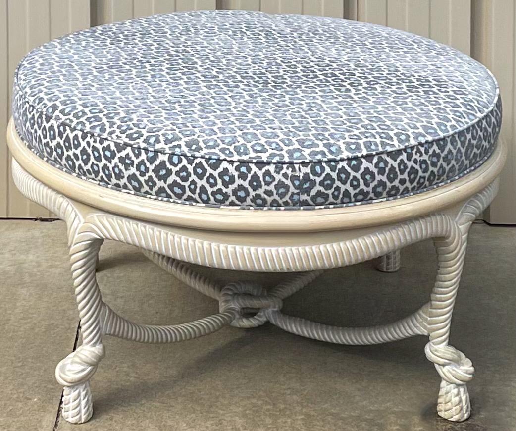 This is a large scale ottoman or coffee table with cerused rope twist frame and new leopard upholstery. It is in very good condition and a transitional family fun piece.