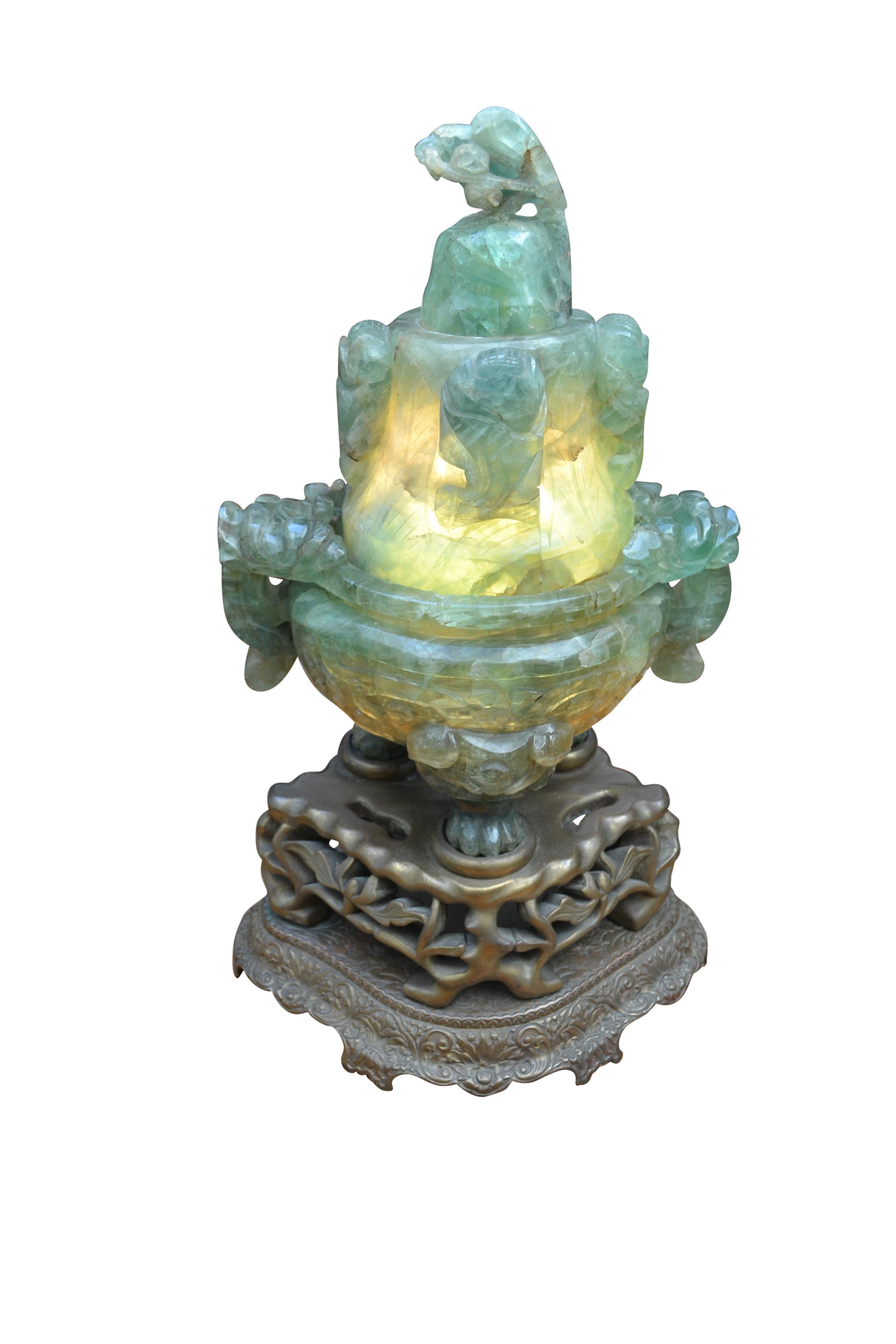 A large ‘flourite/quartz’ lamp, carved with Asian motives and lit from the inside; referred to as a tripod lidded incense burner censer likely from the Republic Period, (1912-1949), carved in the Archaistic style with tapering circular sides