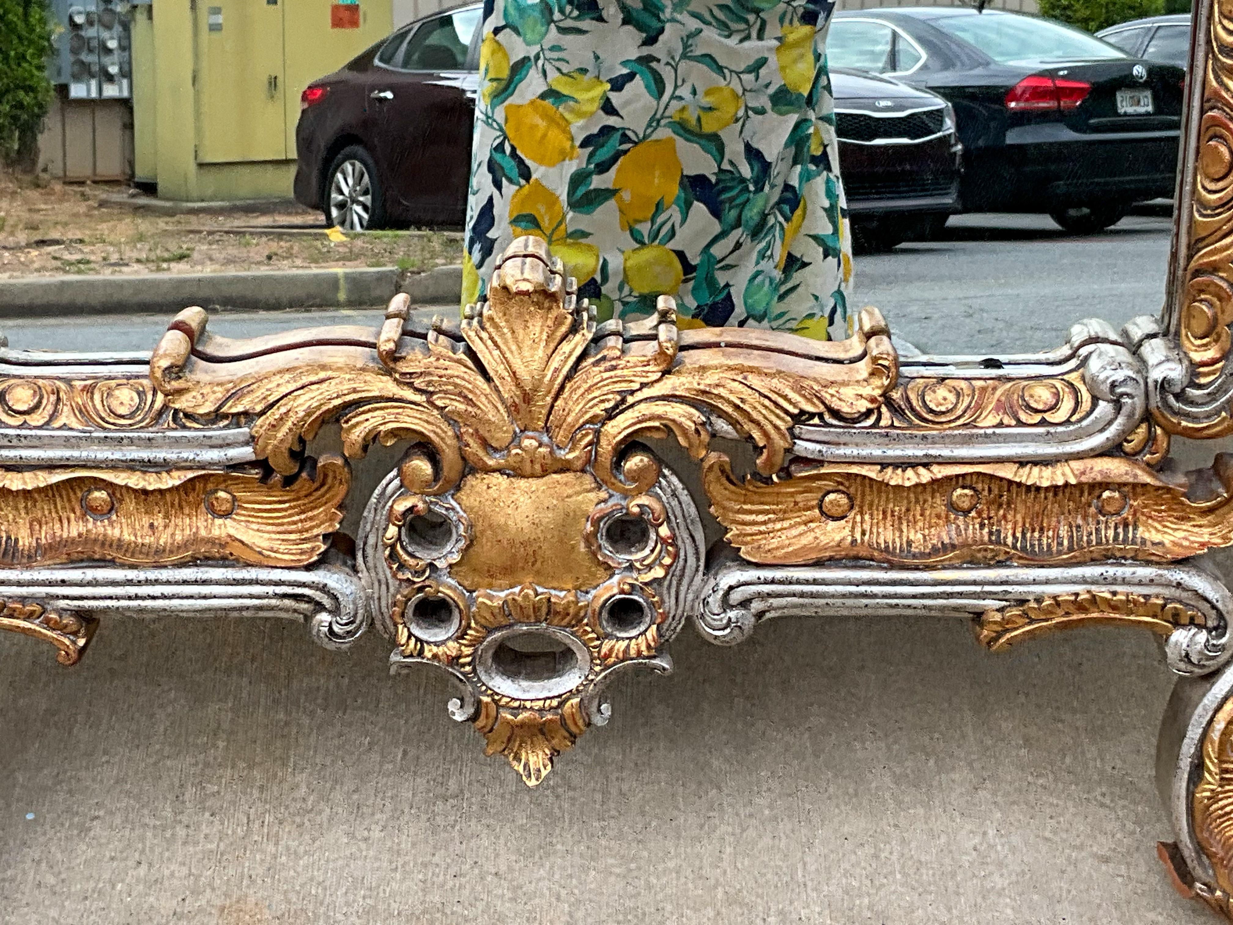 This is a very large scale Chinese Chippendale style giltwood mirror attributed to Maitland-Smith. It is both wood and composition with elaborate detail and both silver and gold gilt. It is unmarked and in very good condition.

My shipping can run