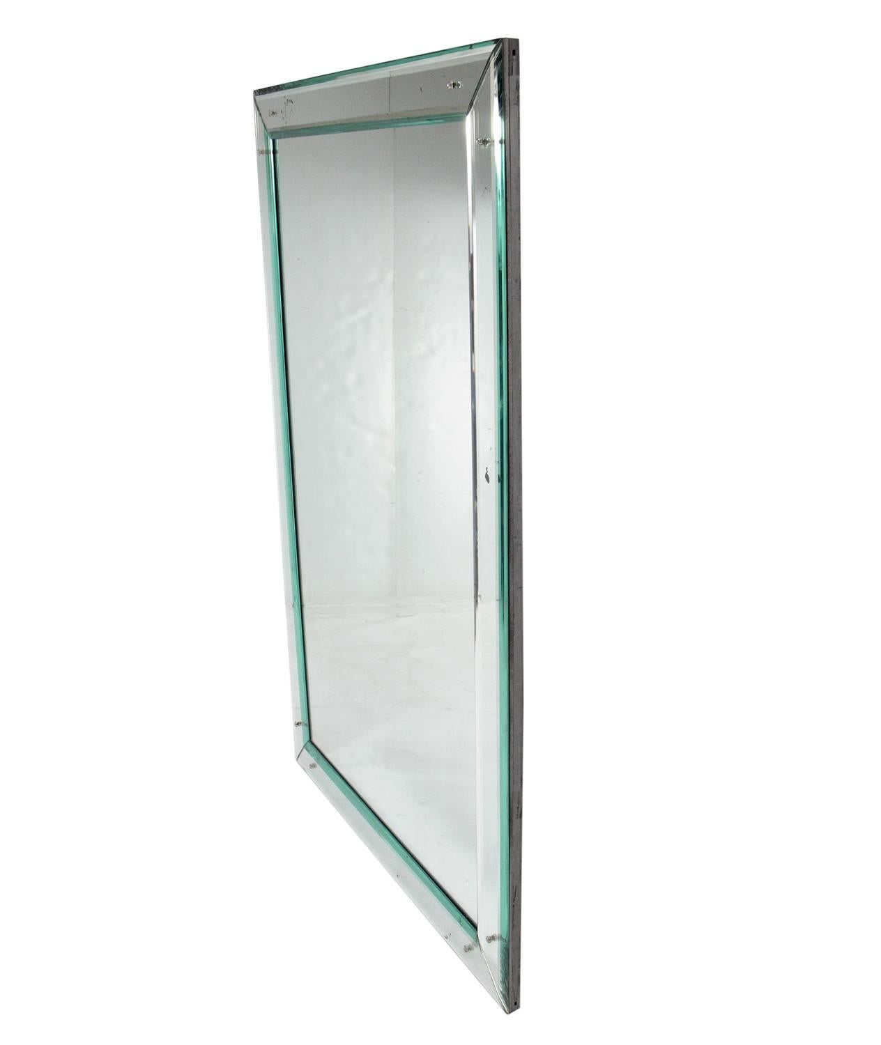 Large-scale clean lined mirror, American, circa 1950s. It measures an impressive 59.5
