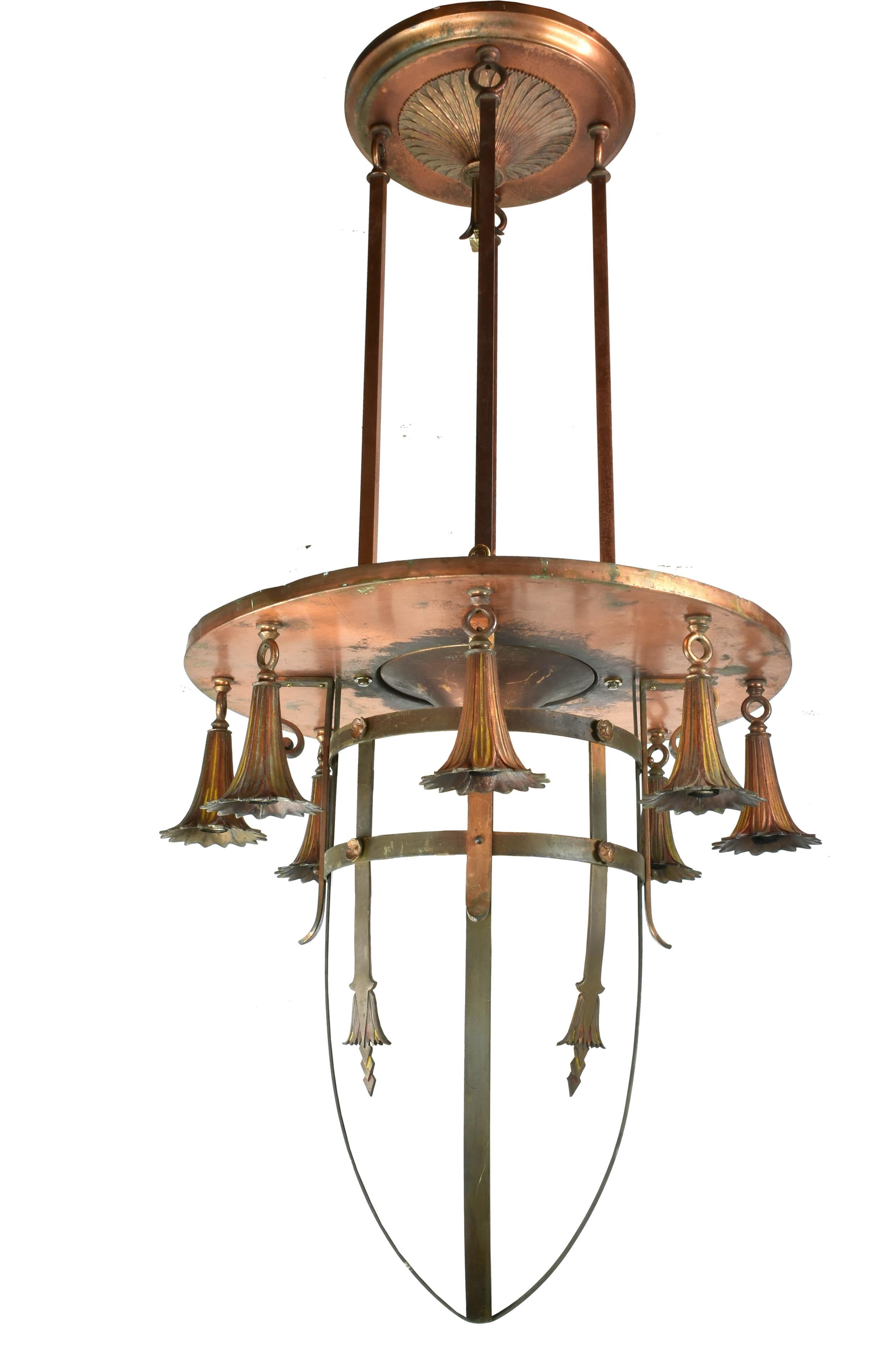 This incredible light is full of Art Deco theatricality, from the amazing patina of the brass worn beautifully over time to the visual strength of the vertical structure of the light. The fixture is painted in polychrome colors, from yellow to aqua