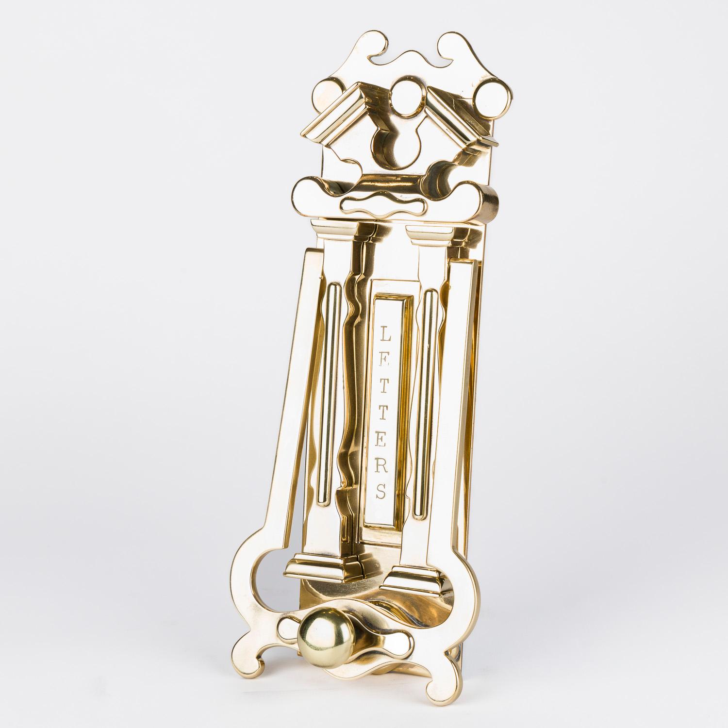 A large scale brass door knocker with letterbox, in the form of a neo-classical portico, English, circa 1900.

Letterbox flap inscribed LETTERS. (Flap aperture 129 x 27 mm).

Modern steel door mounting nuts and bolts.


Depth: 2 inches - 5 cm.