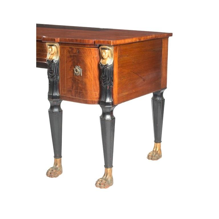 Large scale English regency sideboard table, egyptian motif style with gilt pharaoh head pilasters ending in hairy paw feet figured mahogany ebonized. England. 19th Century

MEASUREMENTS:

38