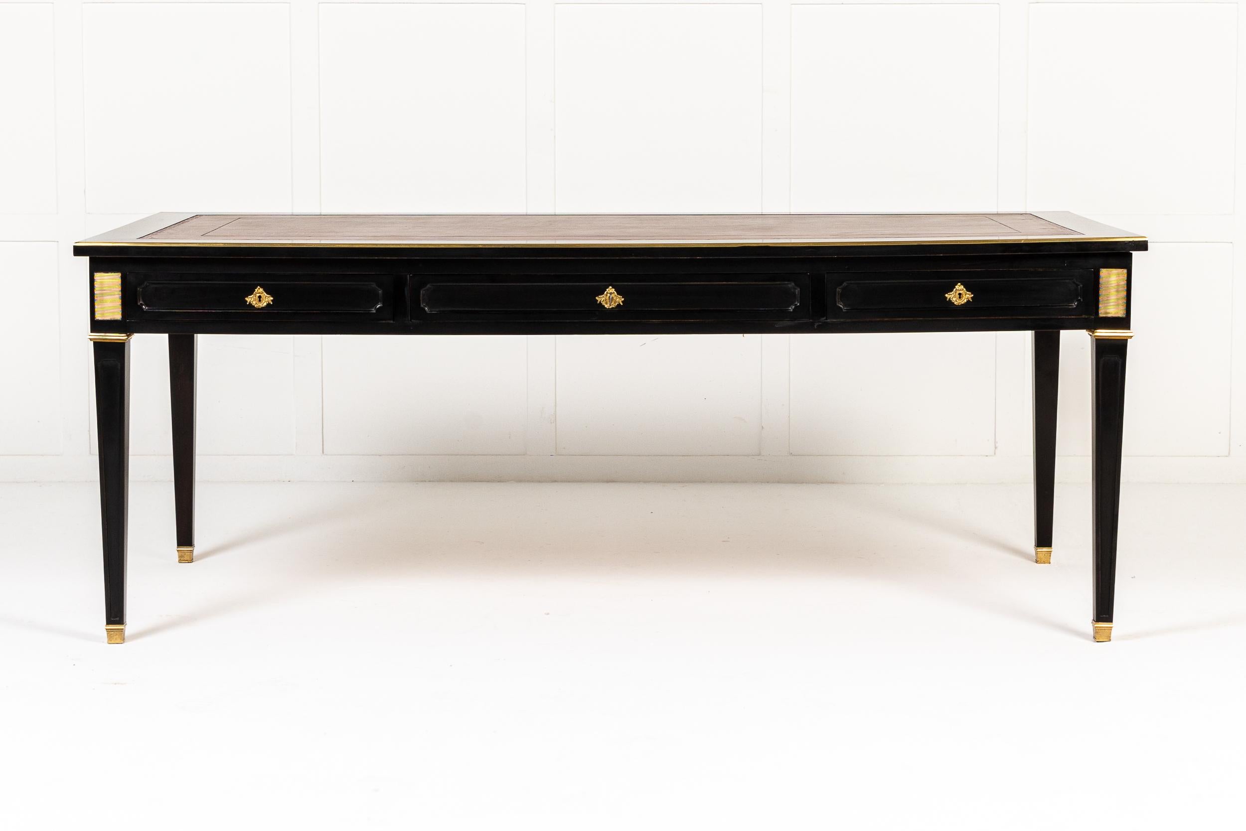 An Excellent Large Scale French Ebonised Bureau Plat or Writing Table c.1950.

This ebonised table is of impressive, large scale. It has cast ormolu mounts of excellent quality in the Louis XVI neoclassical manner. There are two pull out slides with