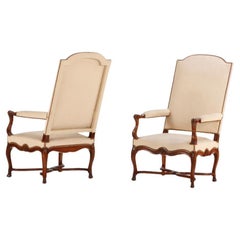 Large scale French walnut open arm chairs with hooved feet C 1900.