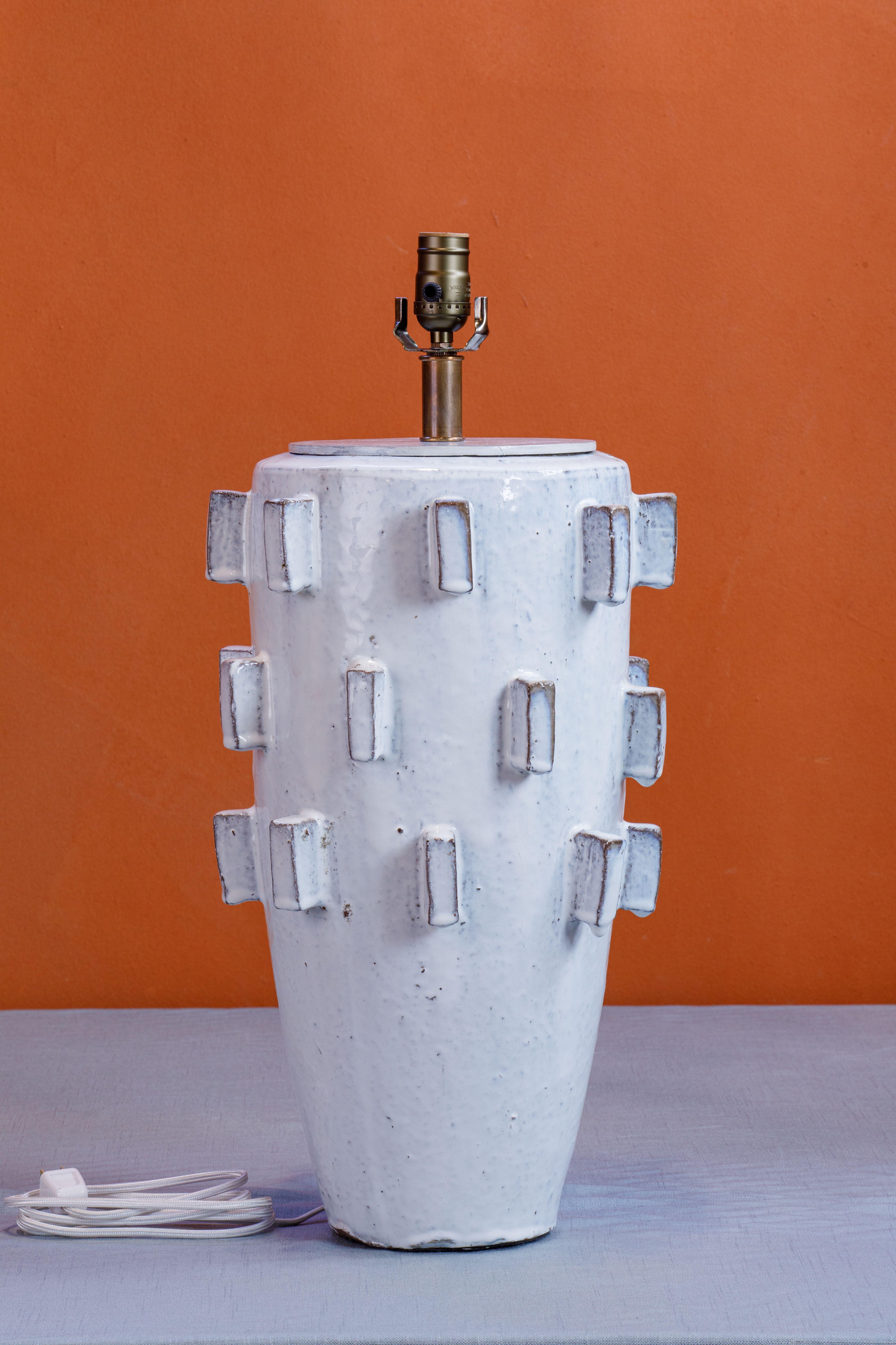 21 inches tall to the top of socket with a 5.5 inch width at its base. The widest width of the lamp is 12 inches. The lamps have a wonderful glaze and are substantial. The lamps have a classic yet fresh appeal and could be called a bit quirky. 