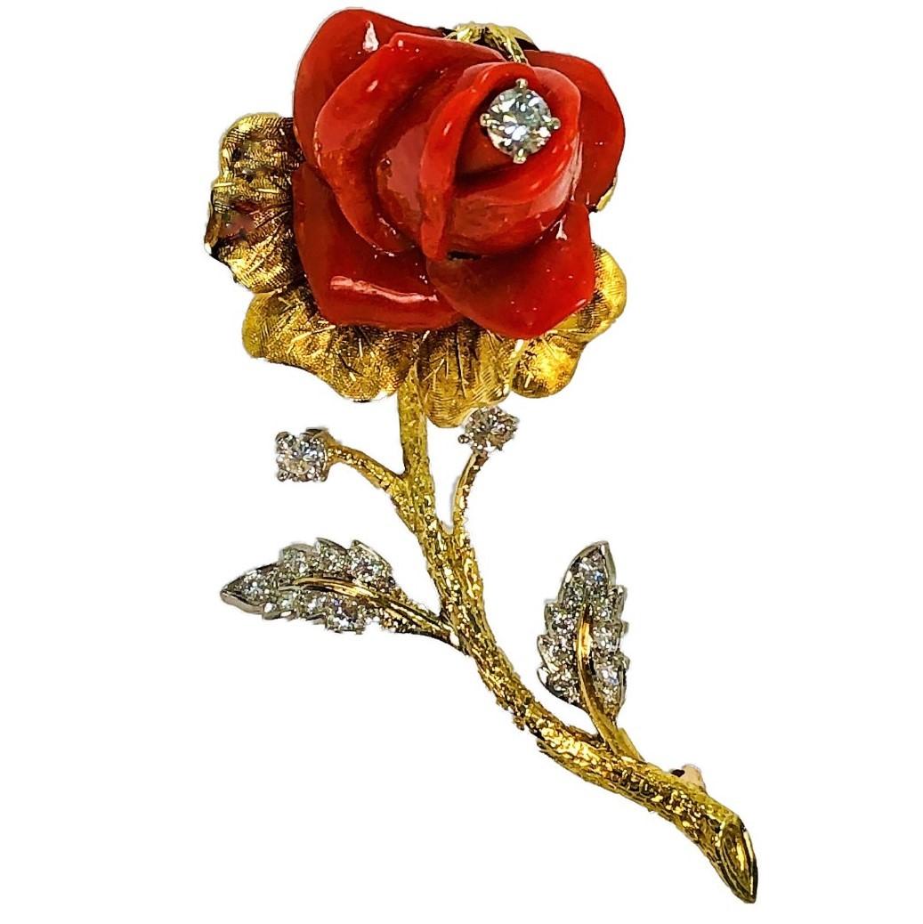Classic 1950's single stem rose, hand carved coral brooch in 18K 
yellow gold. The platinum leaves are set with diamonds.  The three 
larger diamonds plus the twenty smaller diamonds on the leaves, 
weigh an approximate total of 1.50CT The rose