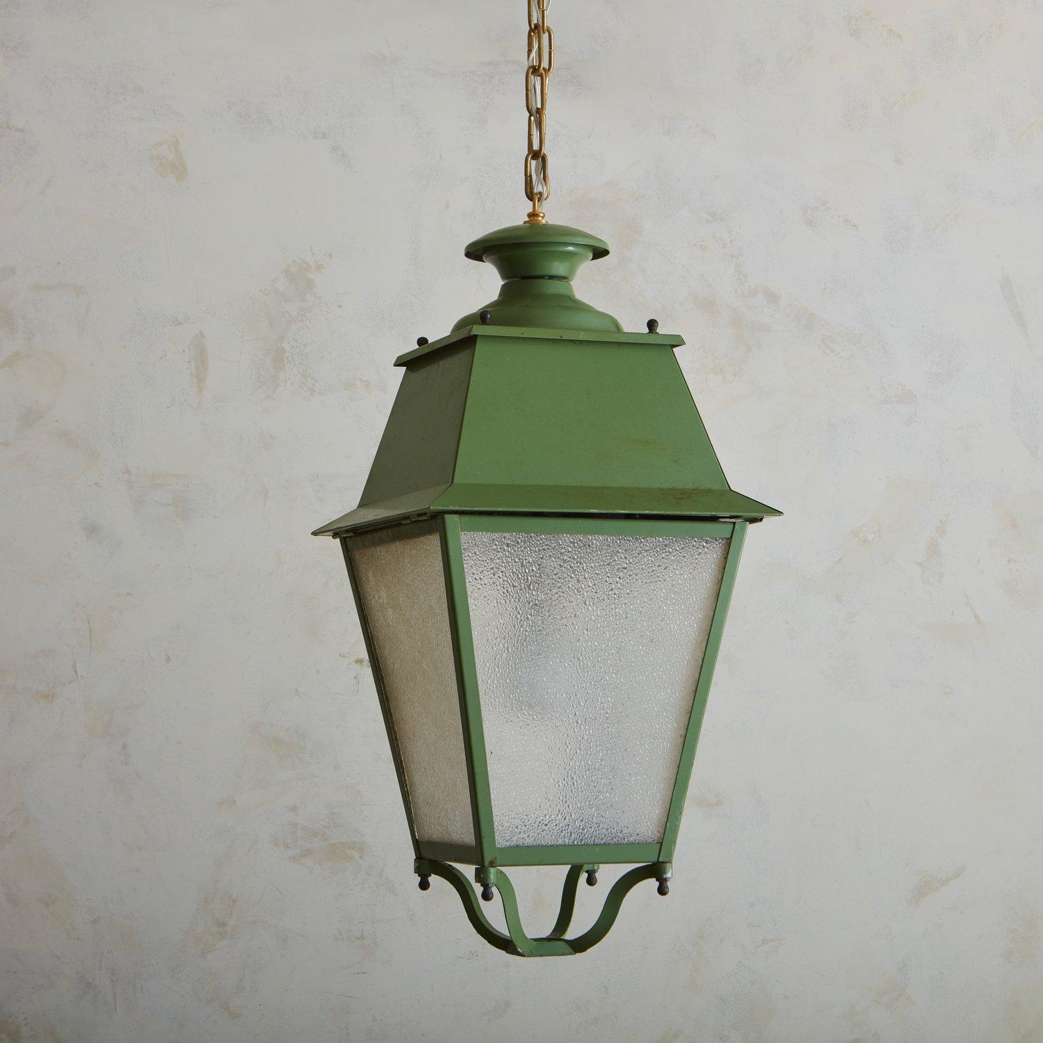 A large scale 1950s French lantern featuring a classic profile and painted a beautiful green hue. This fixture was constructed with metal and has four textured glass panels. Sourced in France, 1950s.