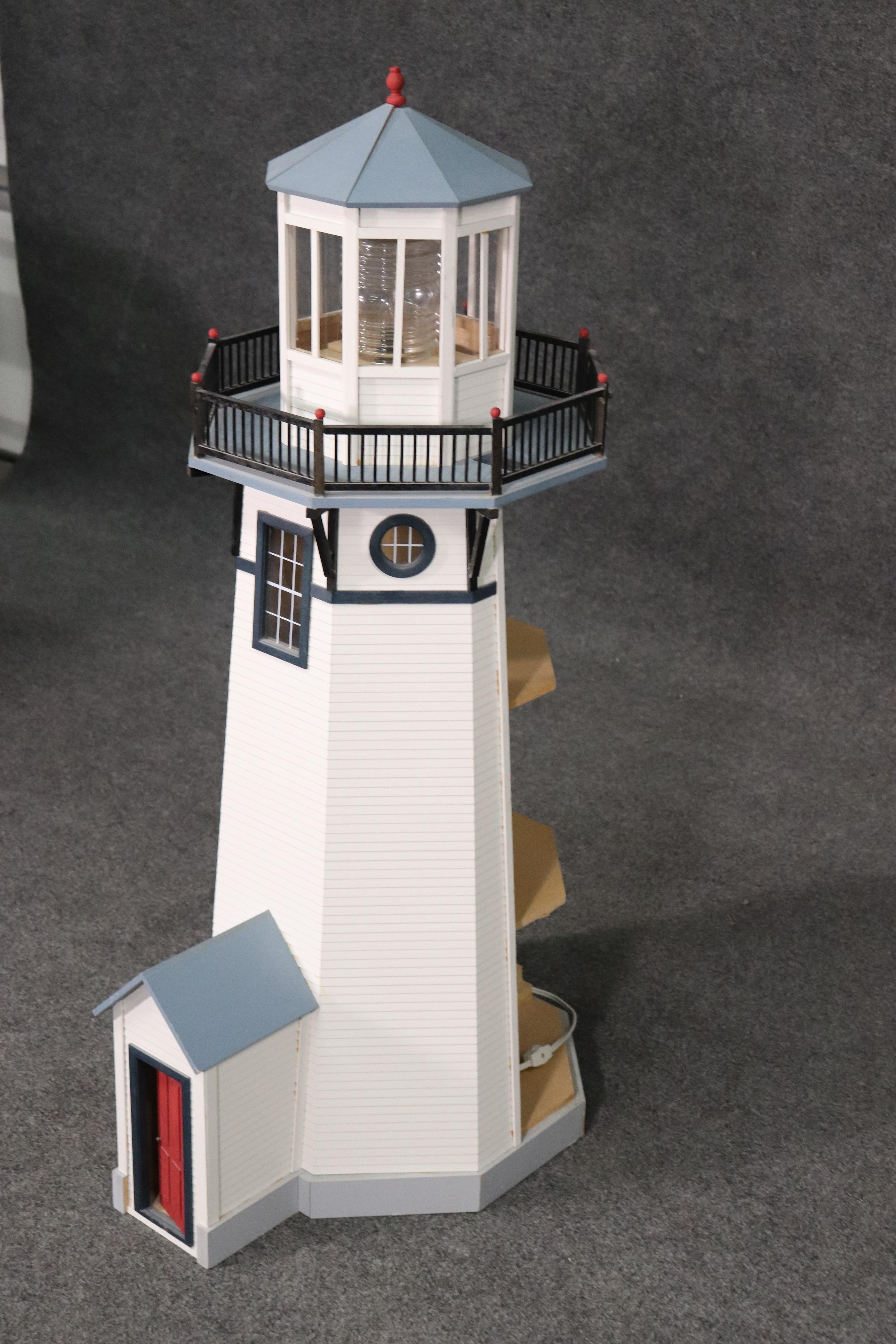 This is a beautifully crafted lighthouse that's been hand crafted and hand painted to accurately replicate what appears to be a New England lighthouse. The piece measures 44 tall x 18 wide x 23 deep. The top section containing the light needs