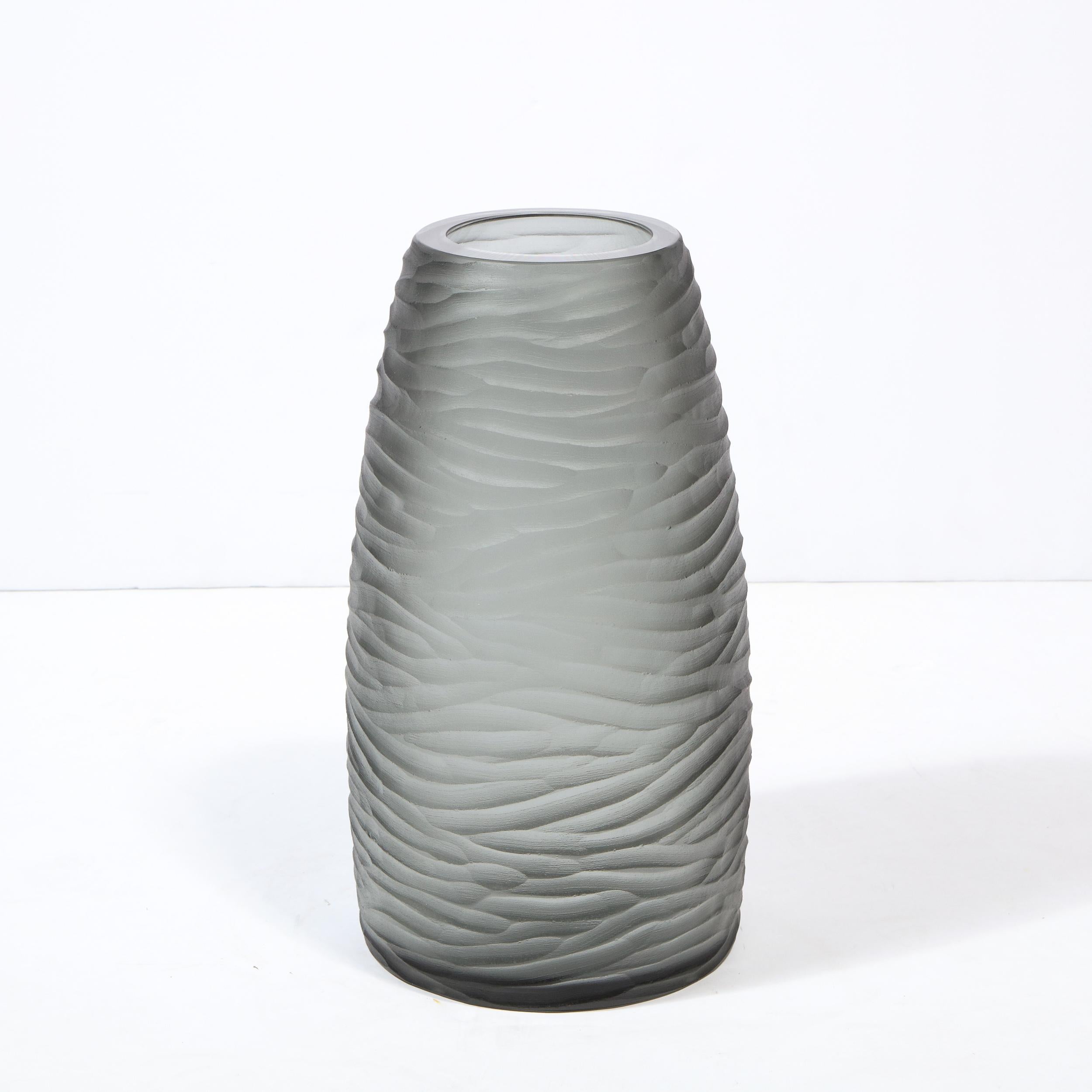 This stunning modernist large scale vase/ umbrella stand was handblown in Murano, Italy- the island off the coast of Venice renowned for centuries for its superlative glass production. It features a cylindrical body that tapers subtly at each end in