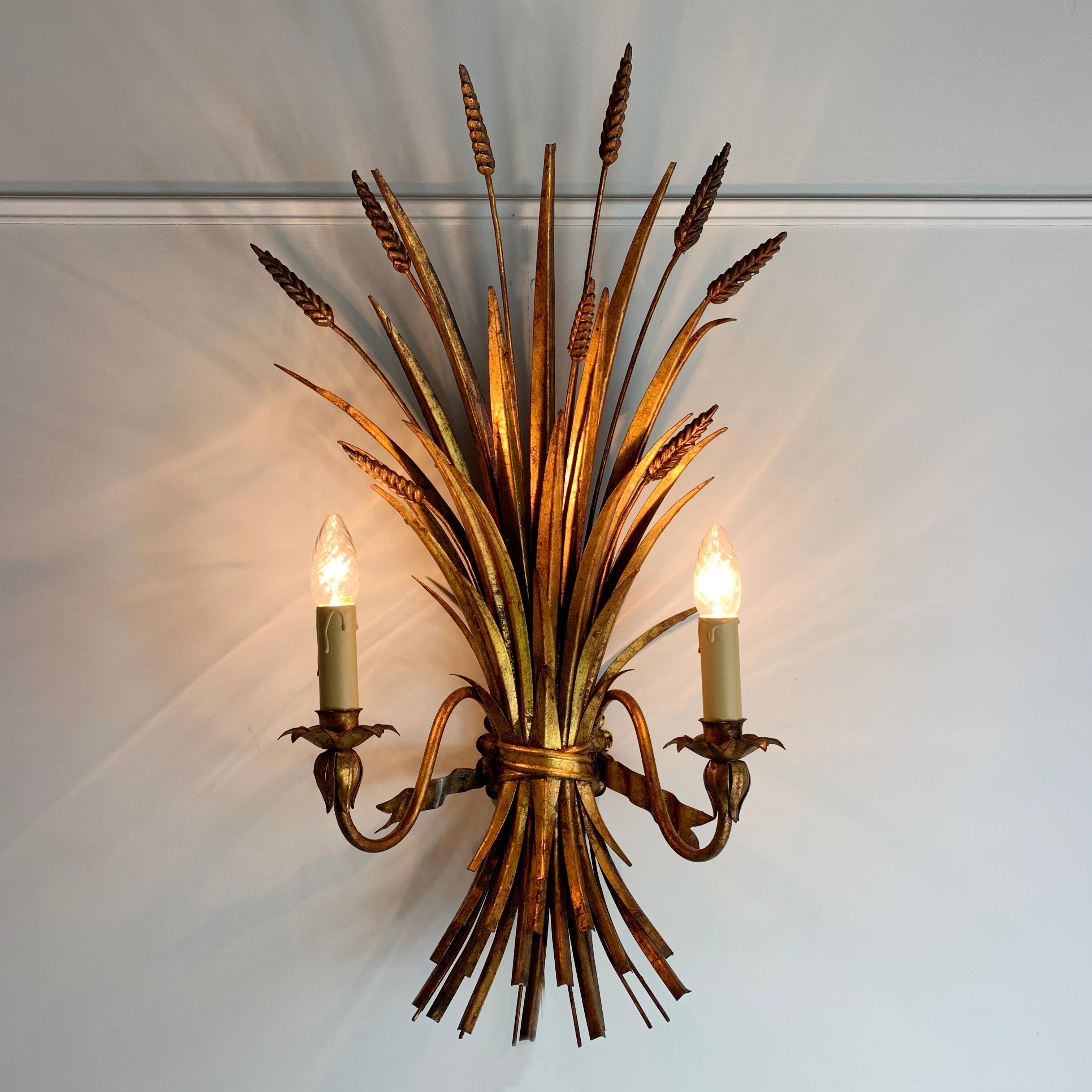 An extremely impressive and very large scale Wheatsheaf wall light by Hans Kogl. Crafted in gilt metal, the huge sprays of wheat form the body of the lamp, which bears two lamp holders to the front. 

Dimensions: 74cm height x 40cm width x 20cm