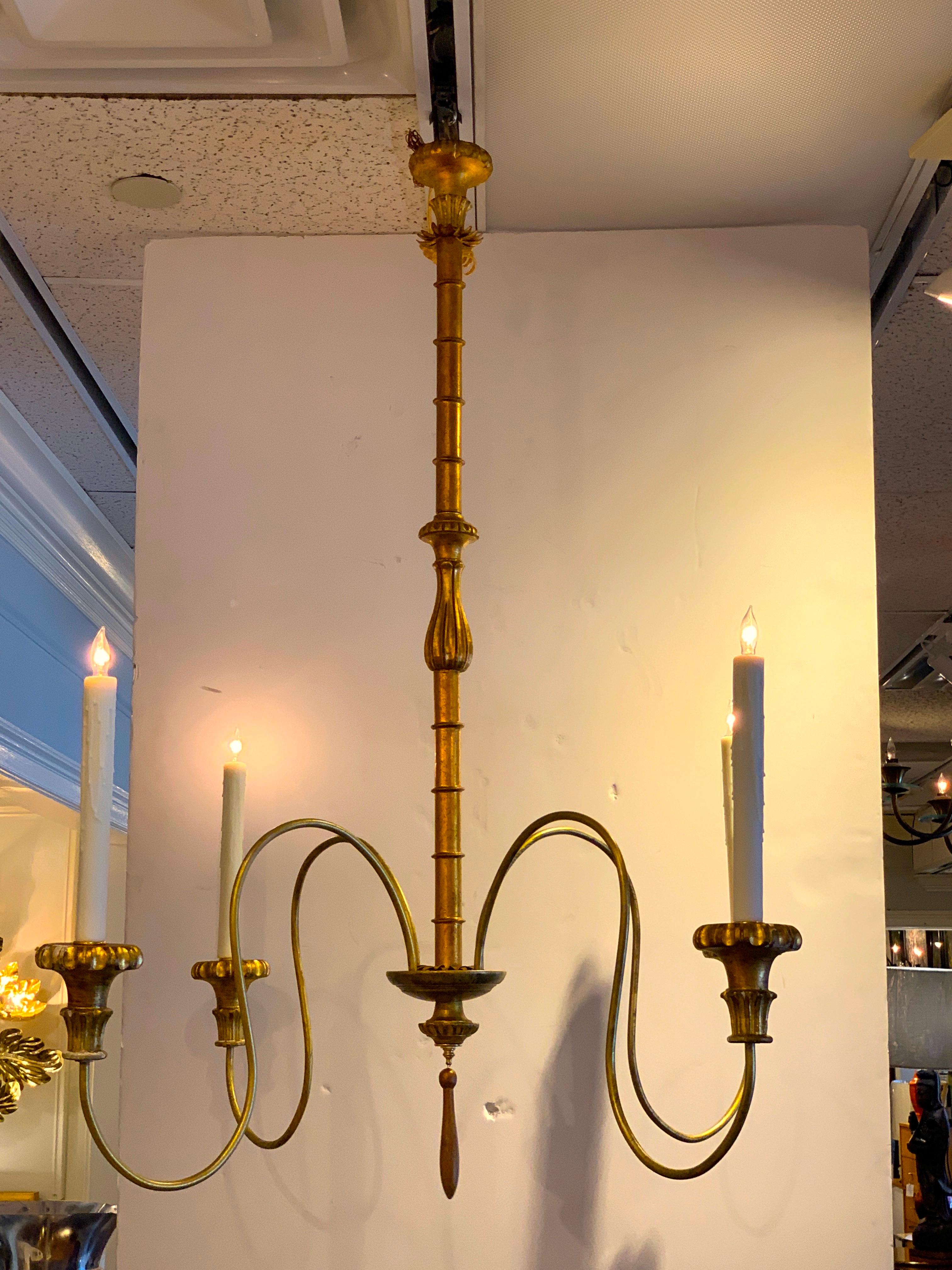 Large scale Hollywood Regency faux bamboo chandelier, four available
Graceful gilt metal faux bamboo center with four gilt metal arms, carved giltwood bobeches
Newly wired.
  
