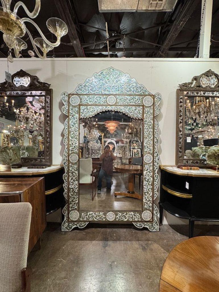 This large-scale inlaid mother of pearl floor mirror from Syria is a stunning piece of home décor that adds a touch of elegance and sophistication to any room. The intricate design and craftsmanship of the mirror showcase the beauty of Syrian