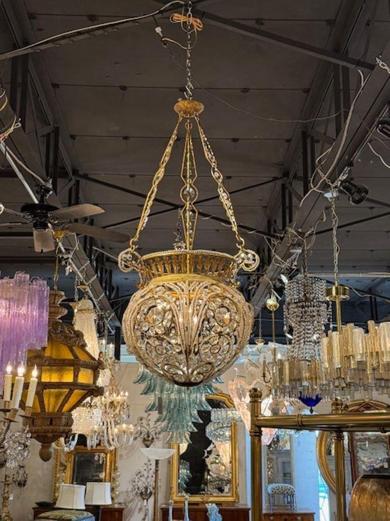Lovely gilt metal and crystal basket chandeliers after Jansen. Very pretty decorative details on these! Beautiful! Note: Price list is for one. We have 2 available. Circa 1960.
54h x 28w