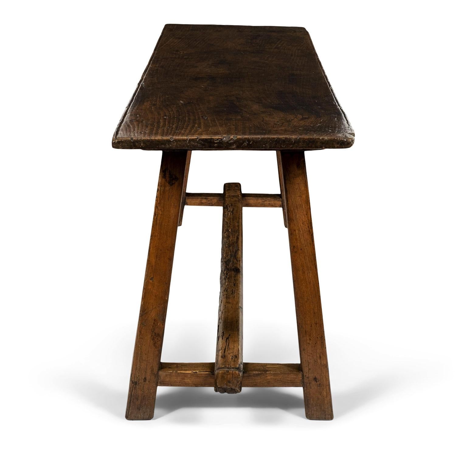 Large-scale Italian walnut console table: rectangular shape top raised upon a trestle base. Gorgeous rich patina and incised decoration along edge of top. Secondary wood is oak. Restored.