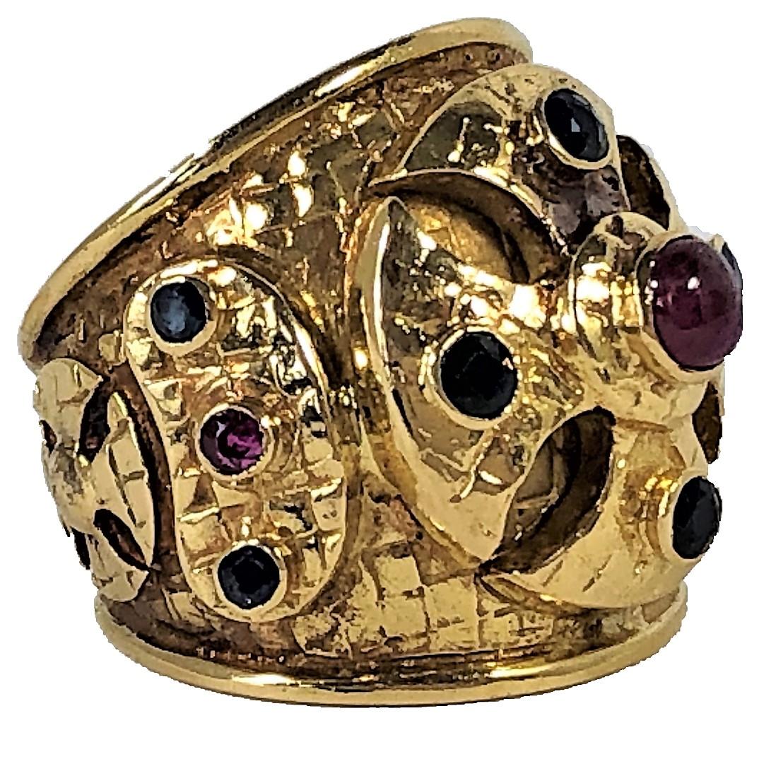 Made of 18K Yellow Gold, this large scale Lalaounis cigar band ring is
set with rubies and sapphires on raised panels. Measures 7/8 inch
long. Gross weight 16.3grams. Ring Size 6. Signed Ilias Lalaounis 750
A21.
