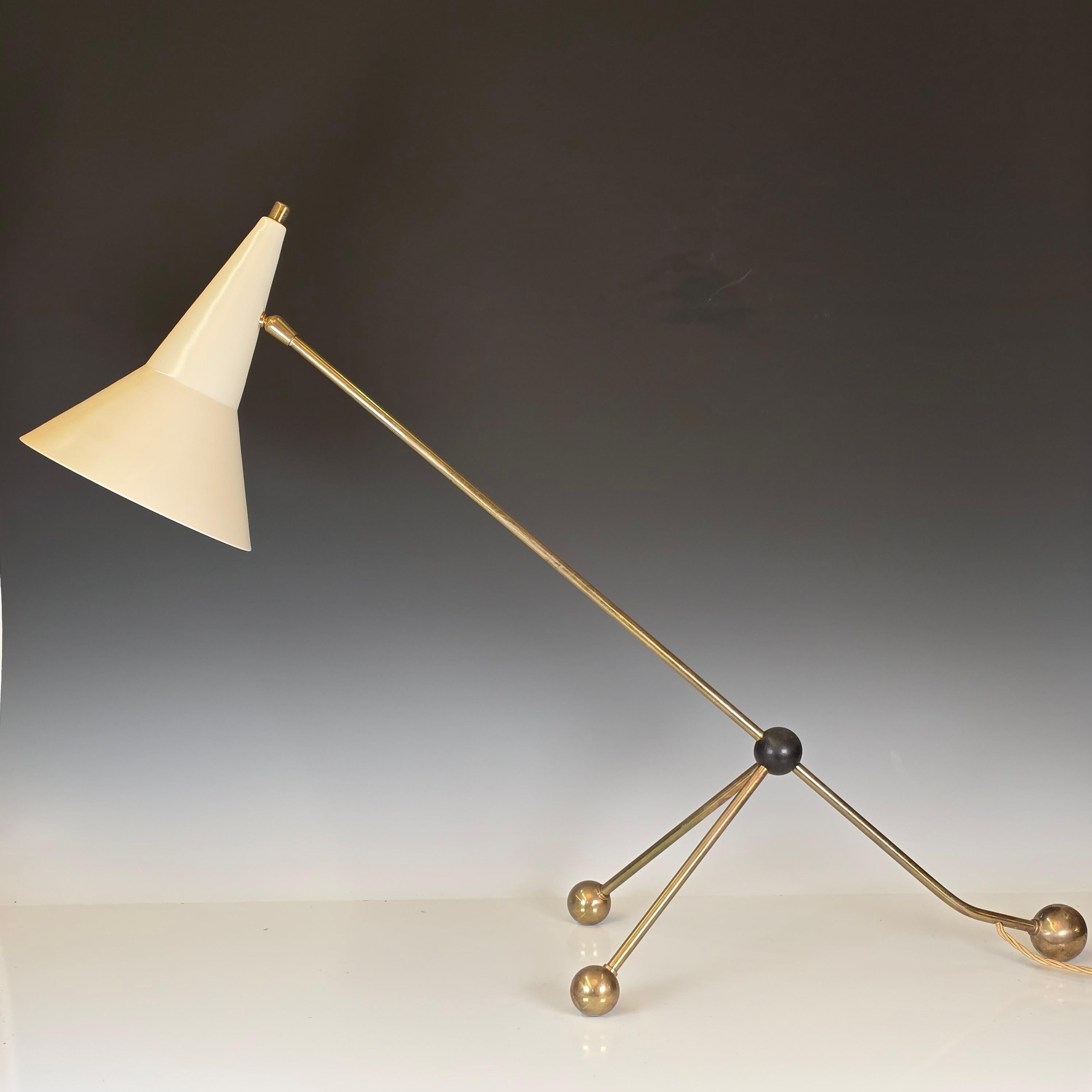A super rare overstayed table or desk lamp by Otto Kolb, circa 1960.  Featuring a tubular brass structure and an ebonized spherical sliding joint which when moved changes the pivot of the lamp.   While not found in any known Kolb publications, the