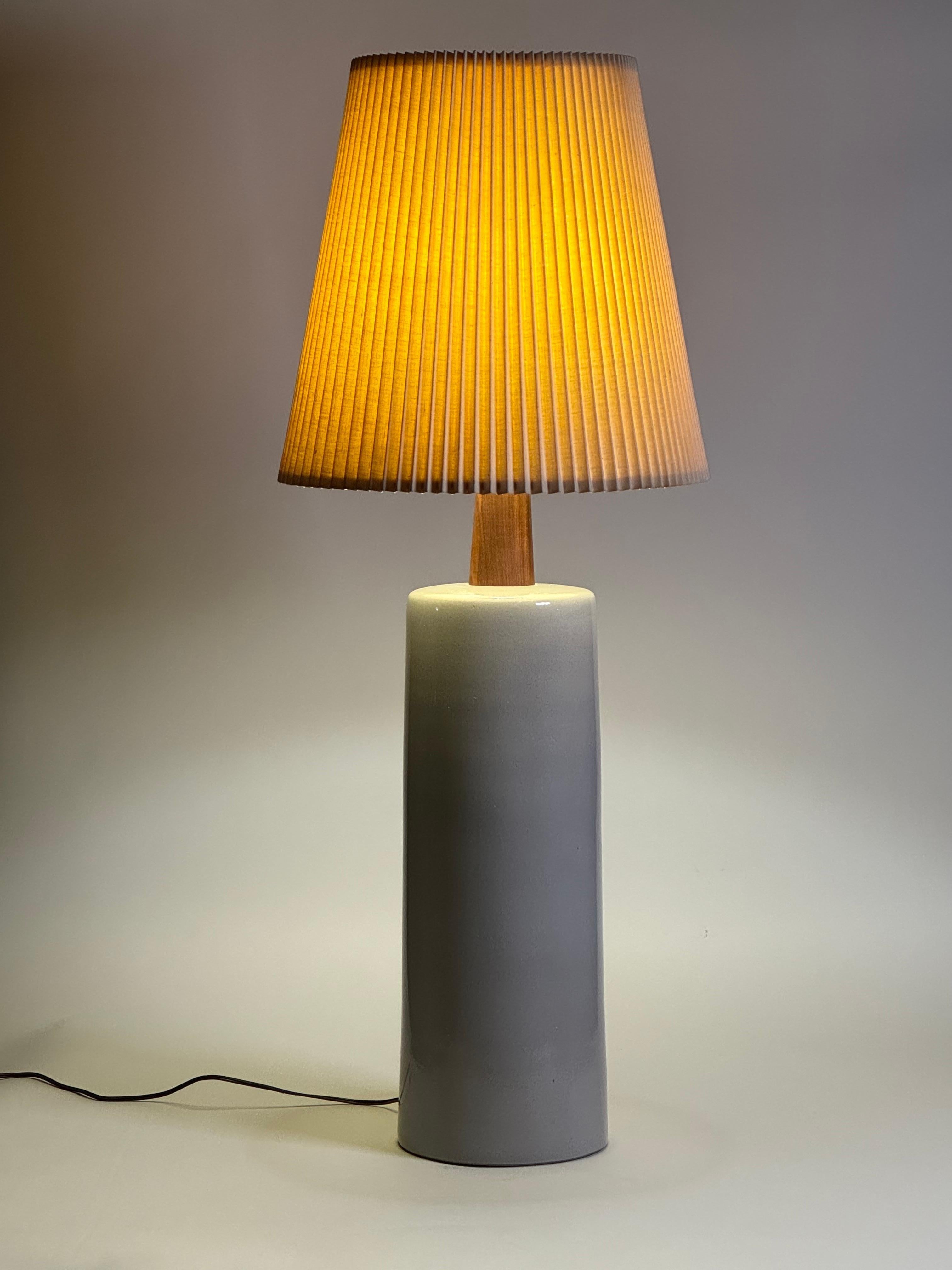 Impressive large scale ceramic and walnut table lamp by Jane and Gordon Martz for their company Marshall Studios. Soft speckled gray glaze in a slightly tapered form with a tapered walnut neck and a circular finial also in walnut. Measures 42.75