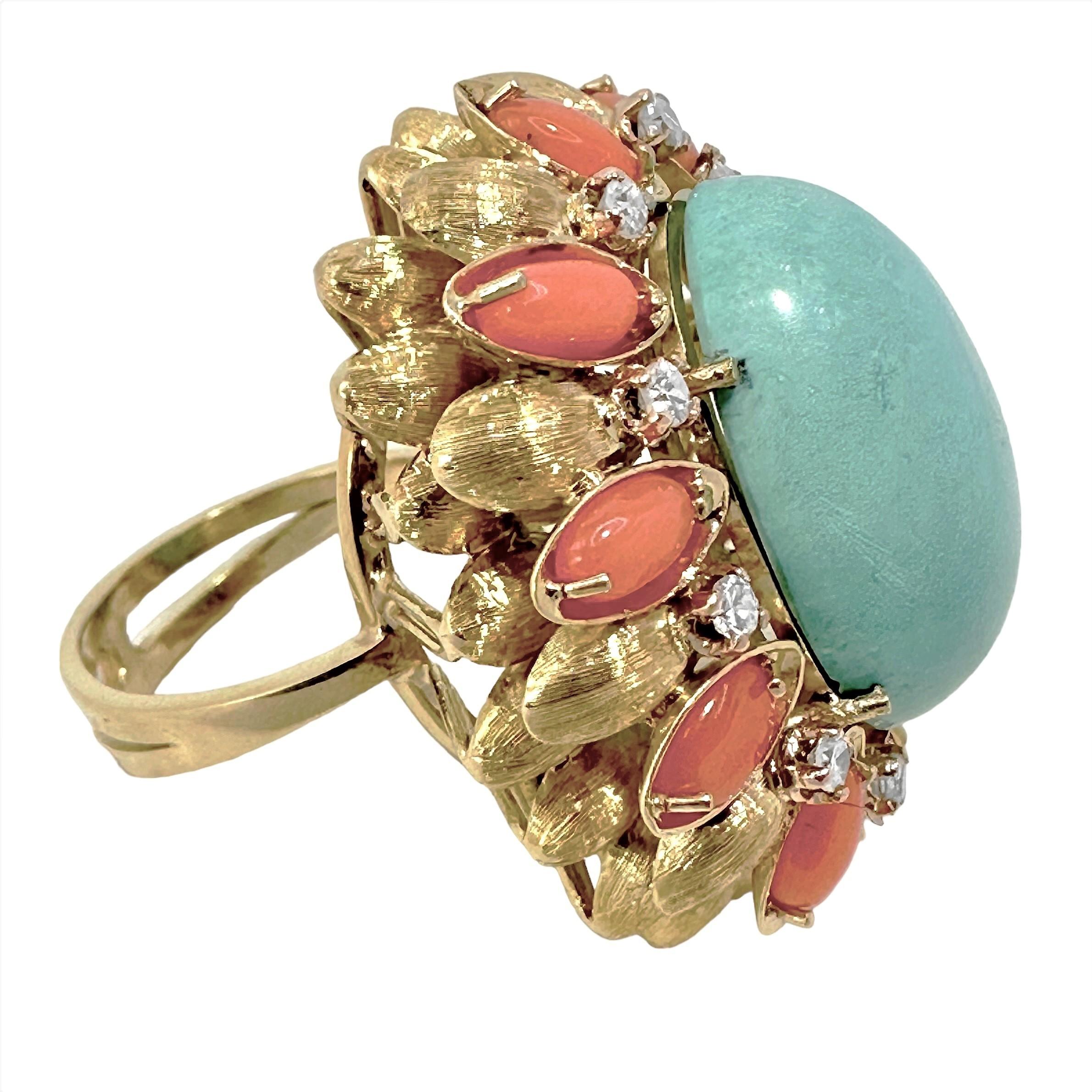 This very large vintage cocktail ring is entirely handmade and finished. Set at the center is a delicate color Persian Turquoise cabochon measuring 3/4 inches by 5/8 inches. This is surrounded by elongated oval shaped Orange Mediterranean Coral