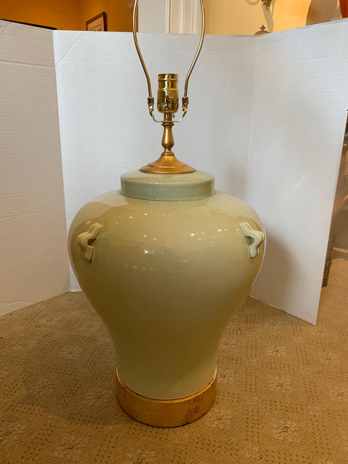 Large scale mid-20th century celadon pottery lamp on custom giltwood base
new wiring.