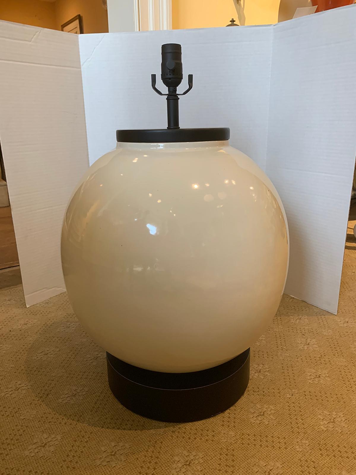 Large scale mid-20th century round white ceramic lamp, black cap and base, circa 1960s
New wiring.