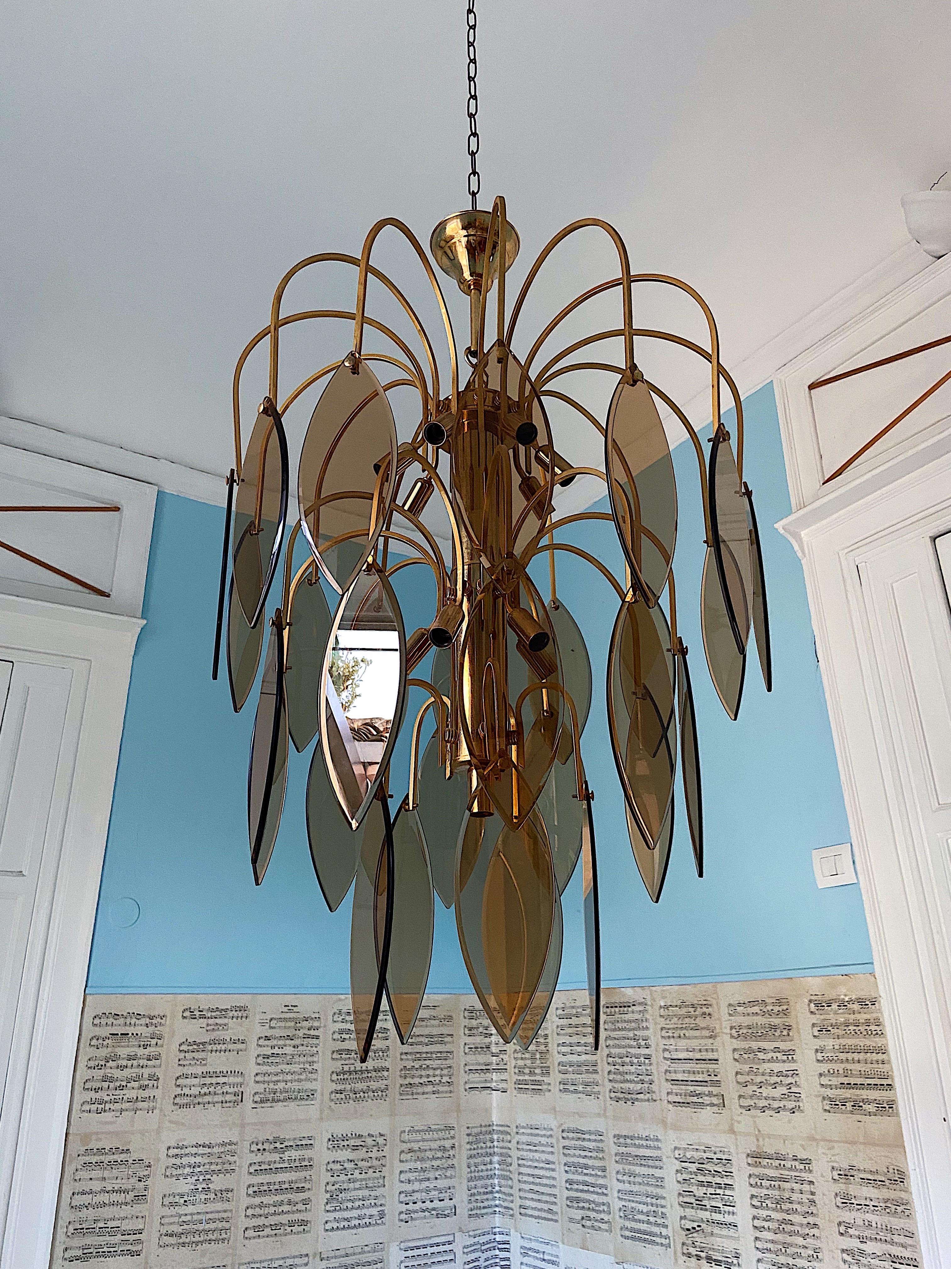 Gorgeous large scale Mid-Century Modern Murano glass chandelier with fume colored glass.
Featuring beautiful cascading leaf shaped glass.
The base has 3 tiers with 29 glass leafs and 13 light bulbs.
This piece is very rare and creates an