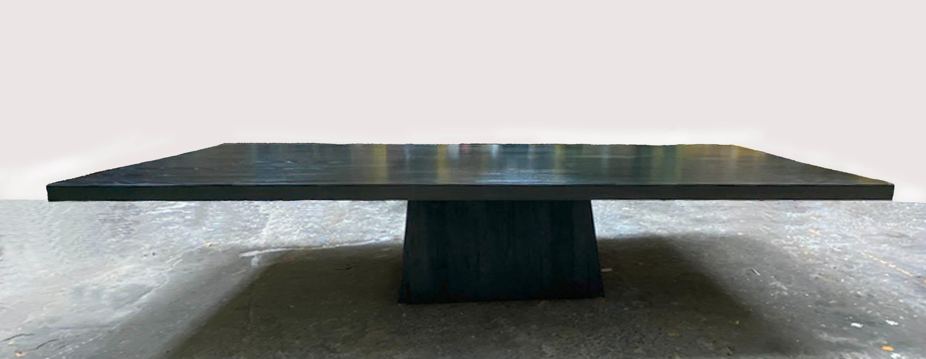 Large scale modern and rustic dining table with trapezoid base. Top is a custom satin gloss ebonized finish on non distressed Cathedral oak. Base is of Douglas fir, highly open grain and distressed with a matte finish. The juxtaposition of the