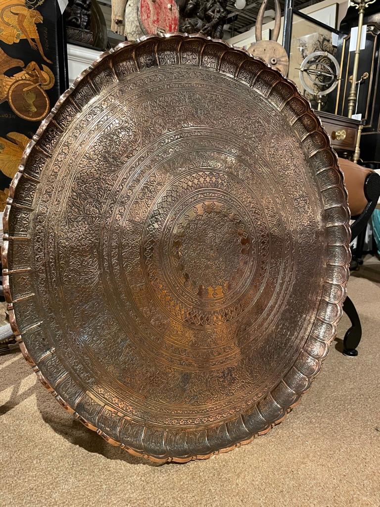 Top quality circa 1900 Moroccan copper tray etched with beautiful Moorish inspired floral decoration. Clearly the work of a master craftsman. Heavy gauge copper with a substantial scalloped rim. 
This is a wonderfully distinctive serving tray, or