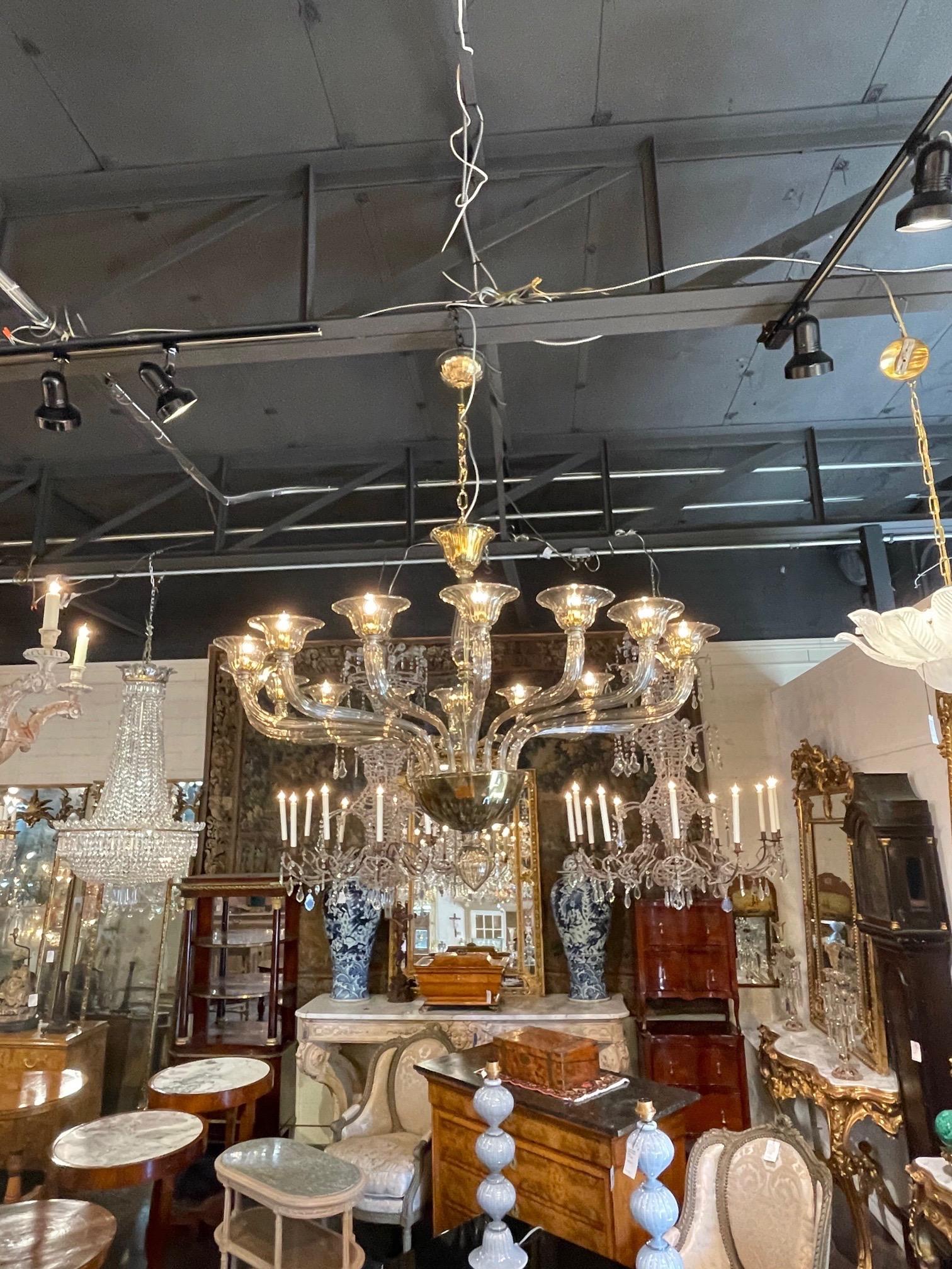 Very impressive large Murano glass chandelier with 16 lights. Featuring a smoke colored glass with a brass interior. Creates a huge presence. Fabulous!