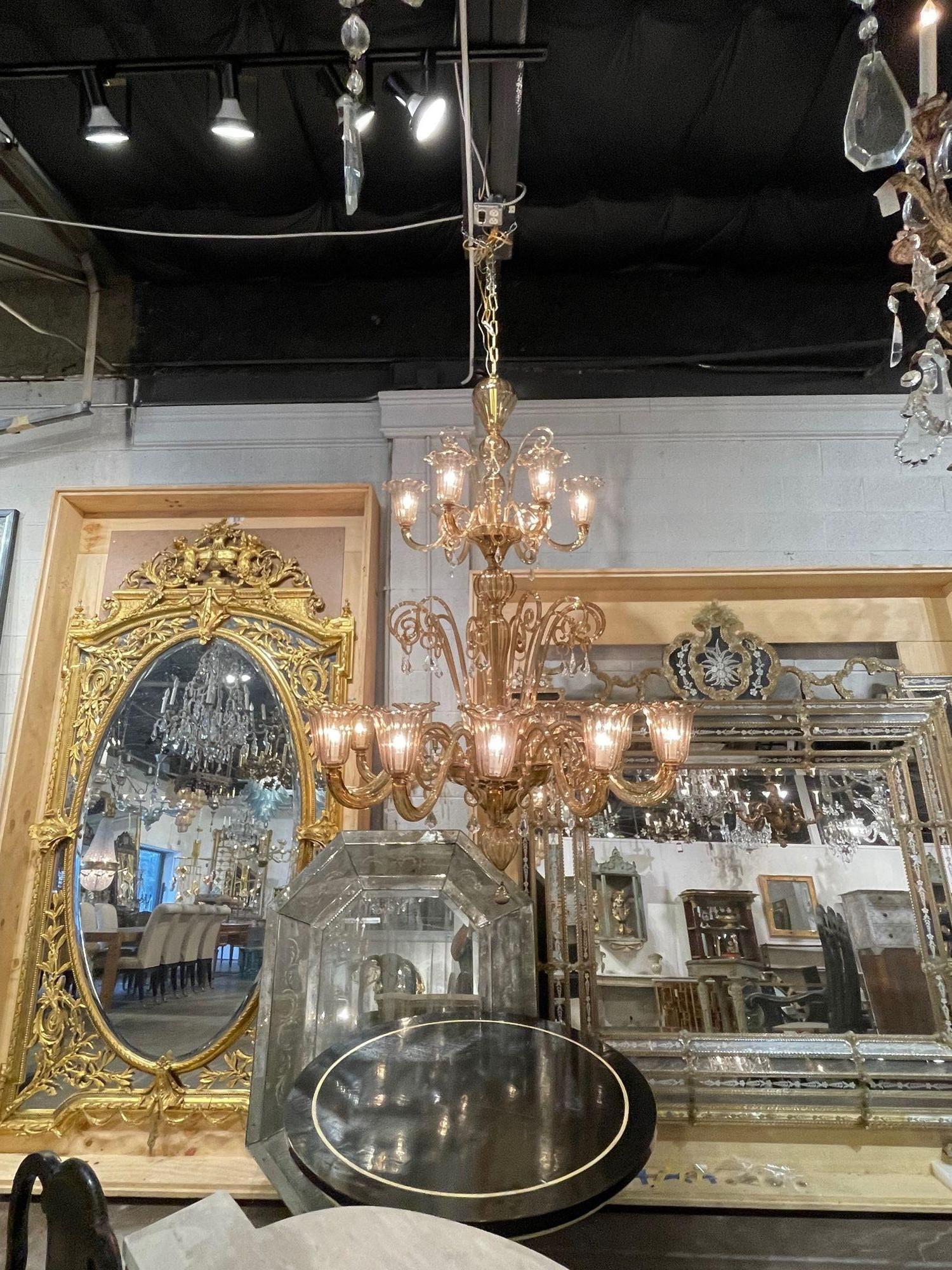 Very impressive large scale Murano glass 2 tier 18 light chandelier. Beautiful decorative arms with golden/champagne colored glistening glass. Absolutely gorgeous!