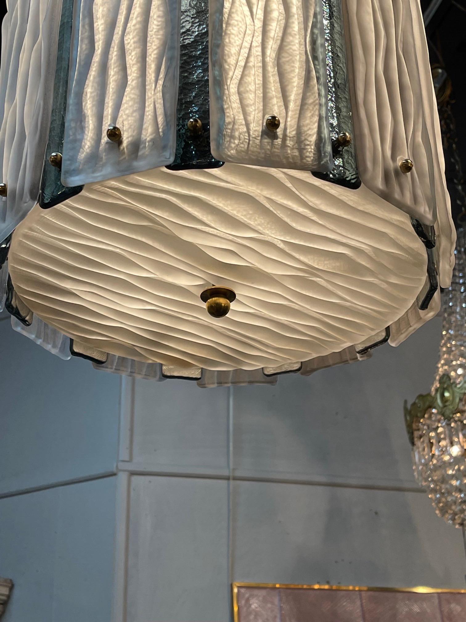 Gorgeous large scale murano glass and brass 2 tone lantern. Pretty color scheme of green and white textured glass in a brass base. Makes a huge impact. Stunning!! Note: the glass is 30 inches in height.