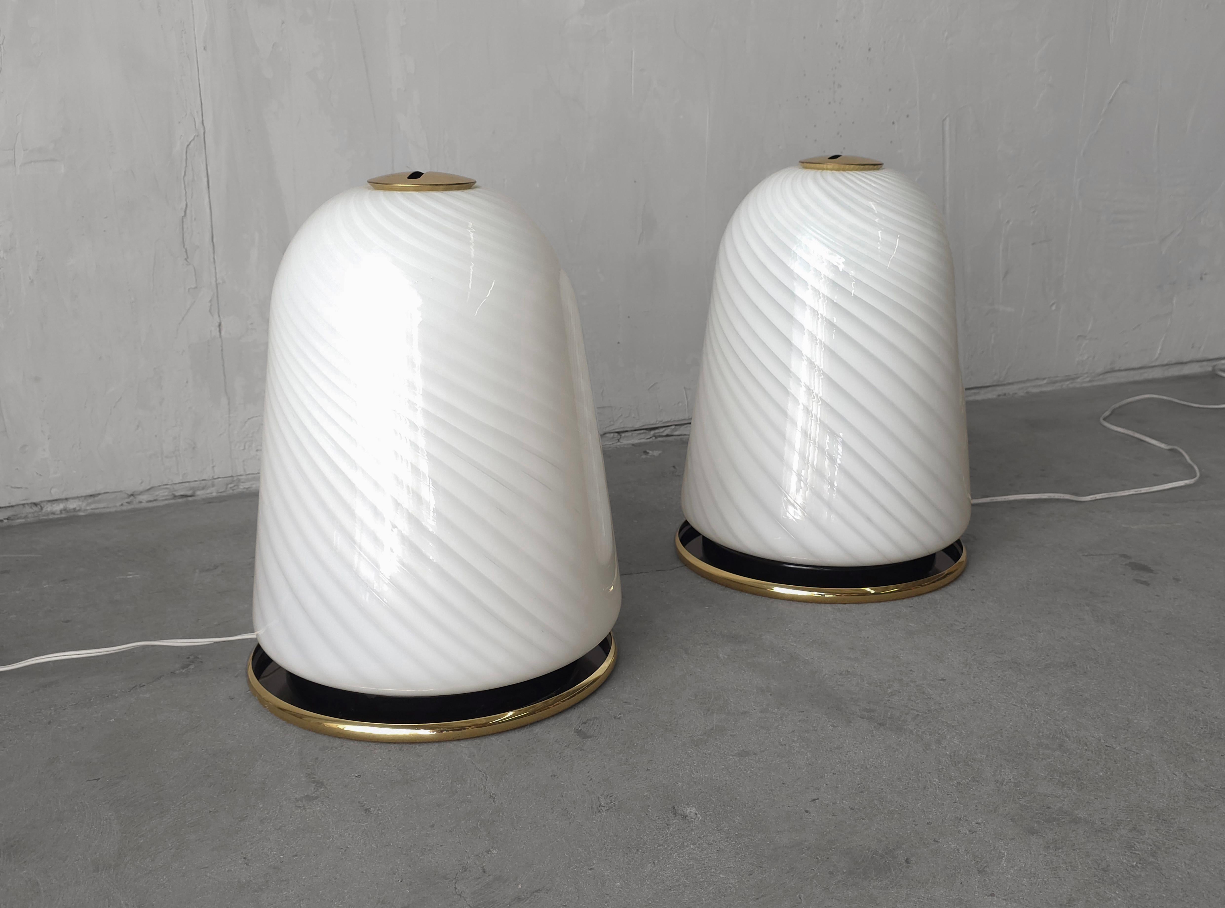 Stunning pair of blown Opaline Murano Glass bell shaped table lamps by Seguso Vetri d'Arte. Lamps are a soft sophisticated shape with milky white and a transparent white swirl. They give off the warmest glow when on, the perfect mood light.  

Lamps