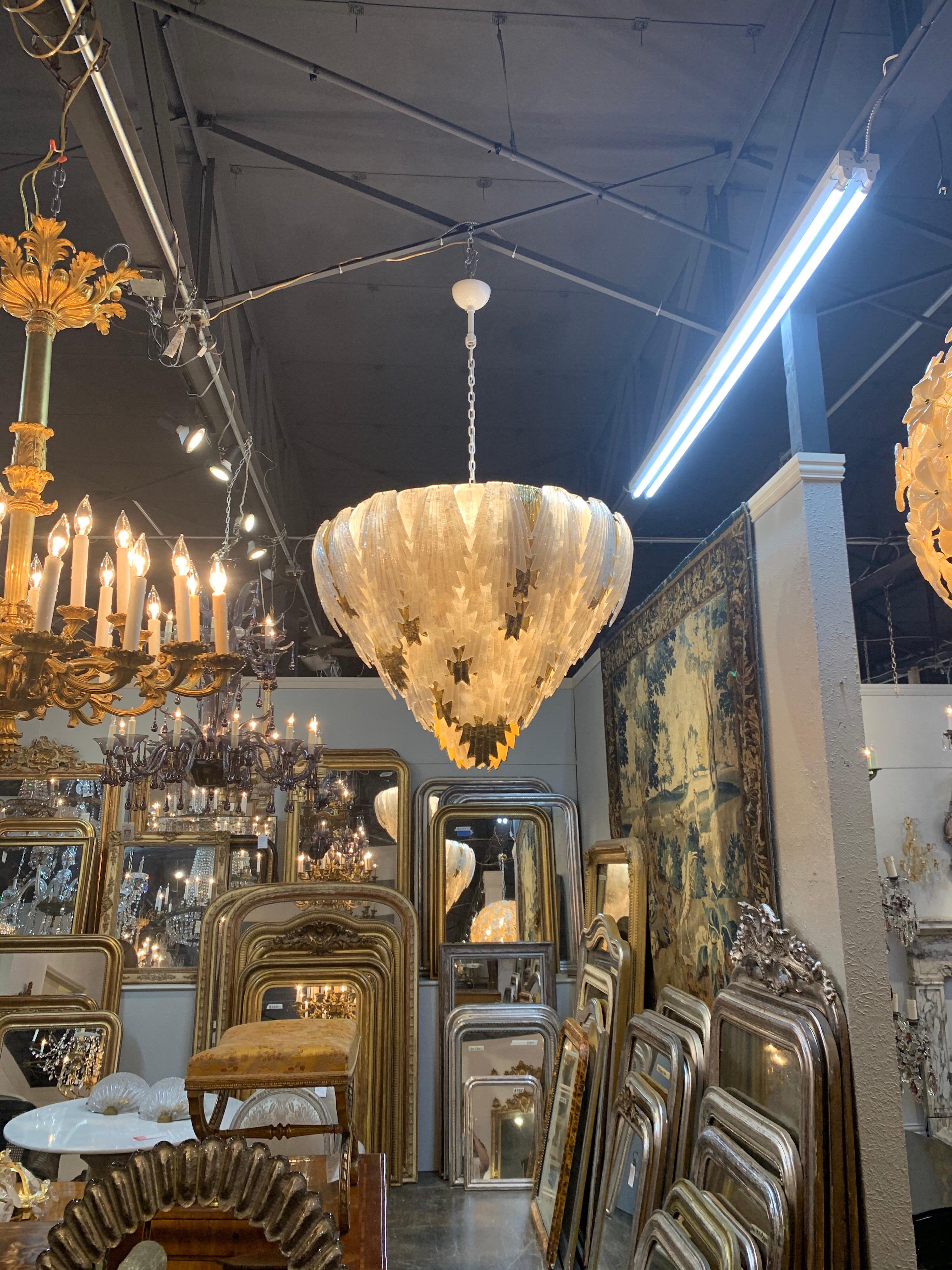 Extraordinary large scale Murano white and gold glass leaf form waterfall chandelier. 
Intertwined white and gold leaves creating a beautiful cascading effect. A truly unique and beautiful fixture. Stunning!