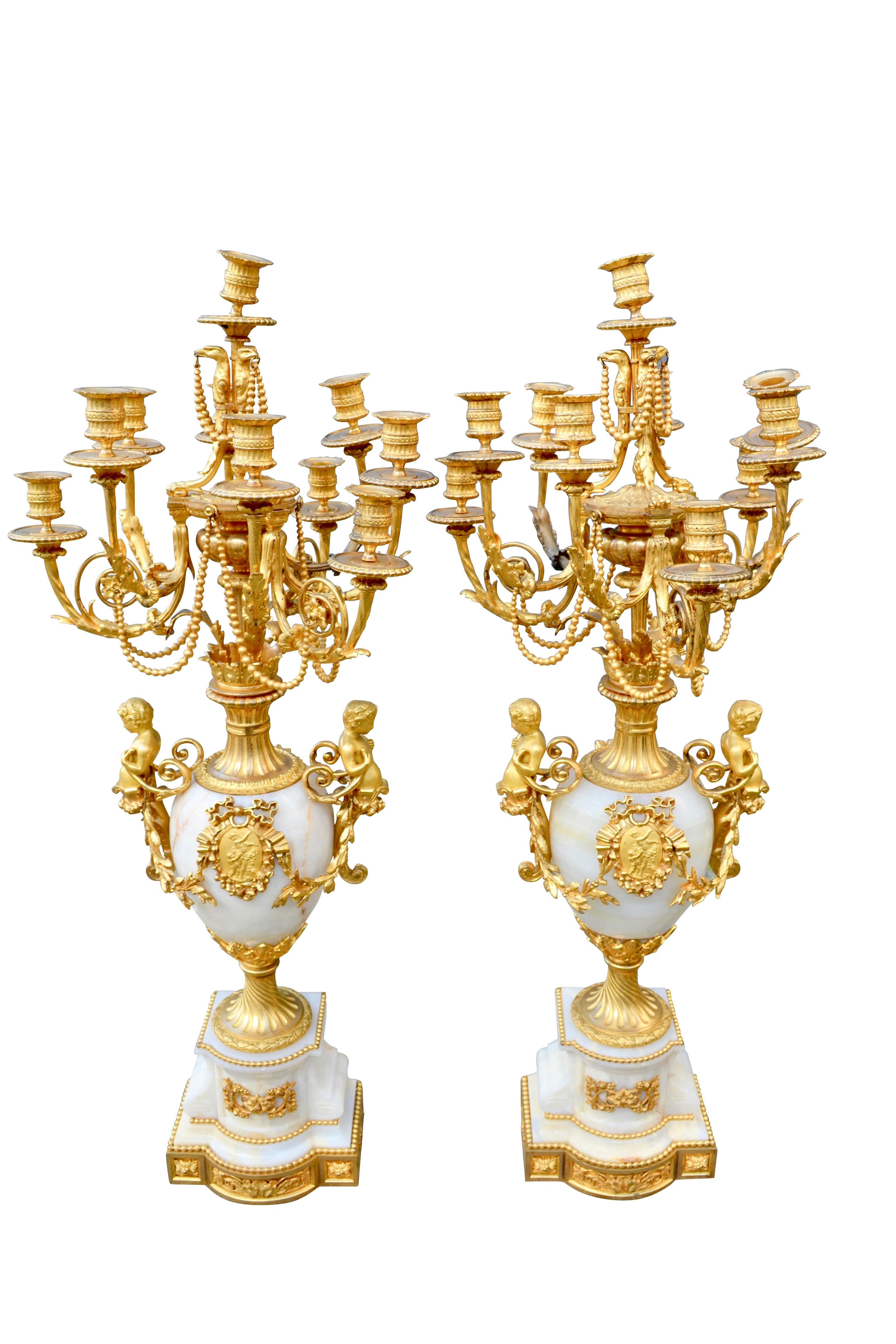 This grand pair of candelabra are of the highest quality, made of carved onyx, and finely cast gilded bronze. They were made during the Napoleon III era in France and are exceptional examples of the decorative arts of the period. They are Louis XVI
