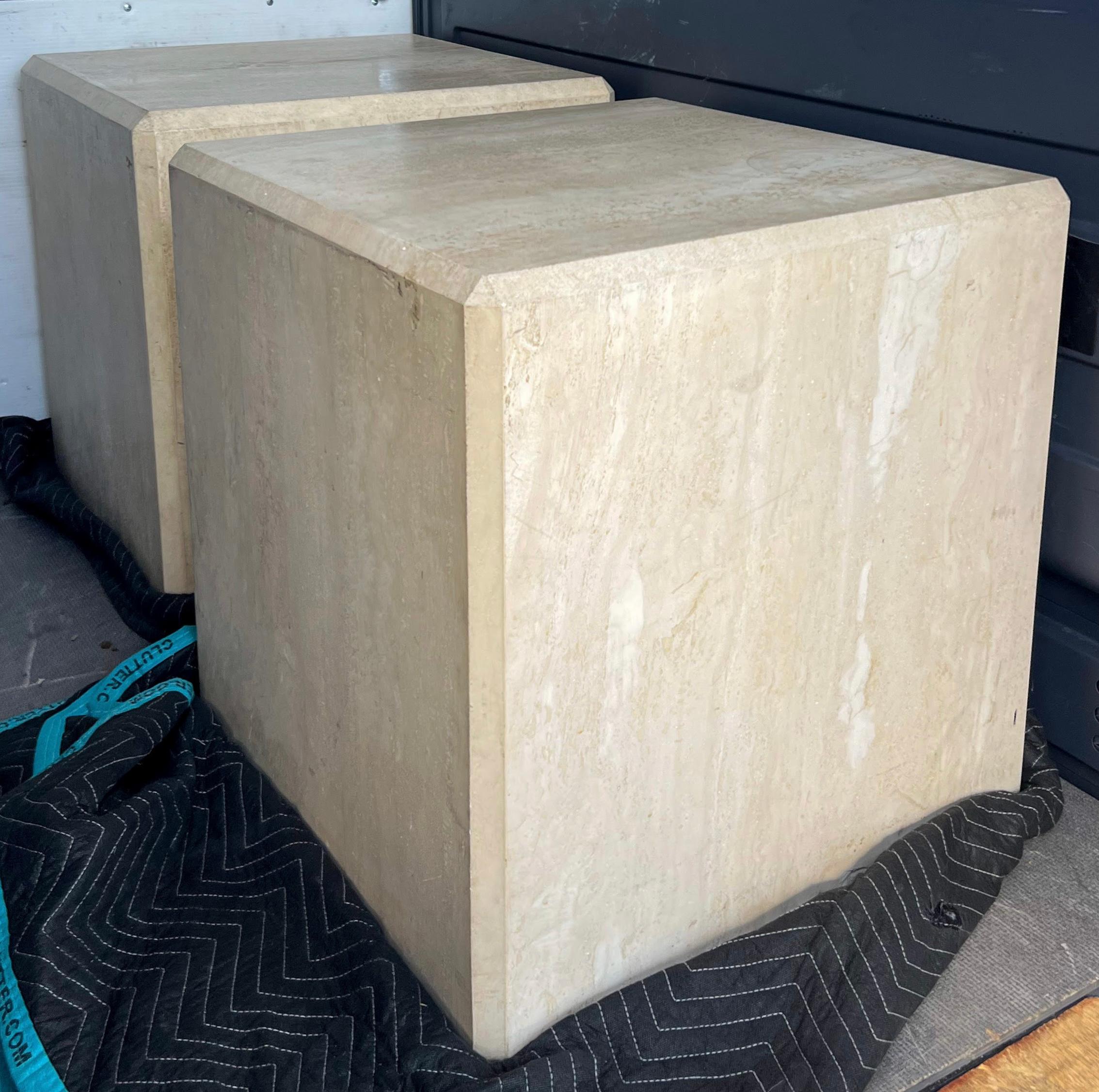This is a beautiful pair of large scale organic modern travertine side tables. They actually are thick sheets applied around a wooden core. The edges are beveled. Each table is approximately 180 lbs. They are unmarked and in very good condition.