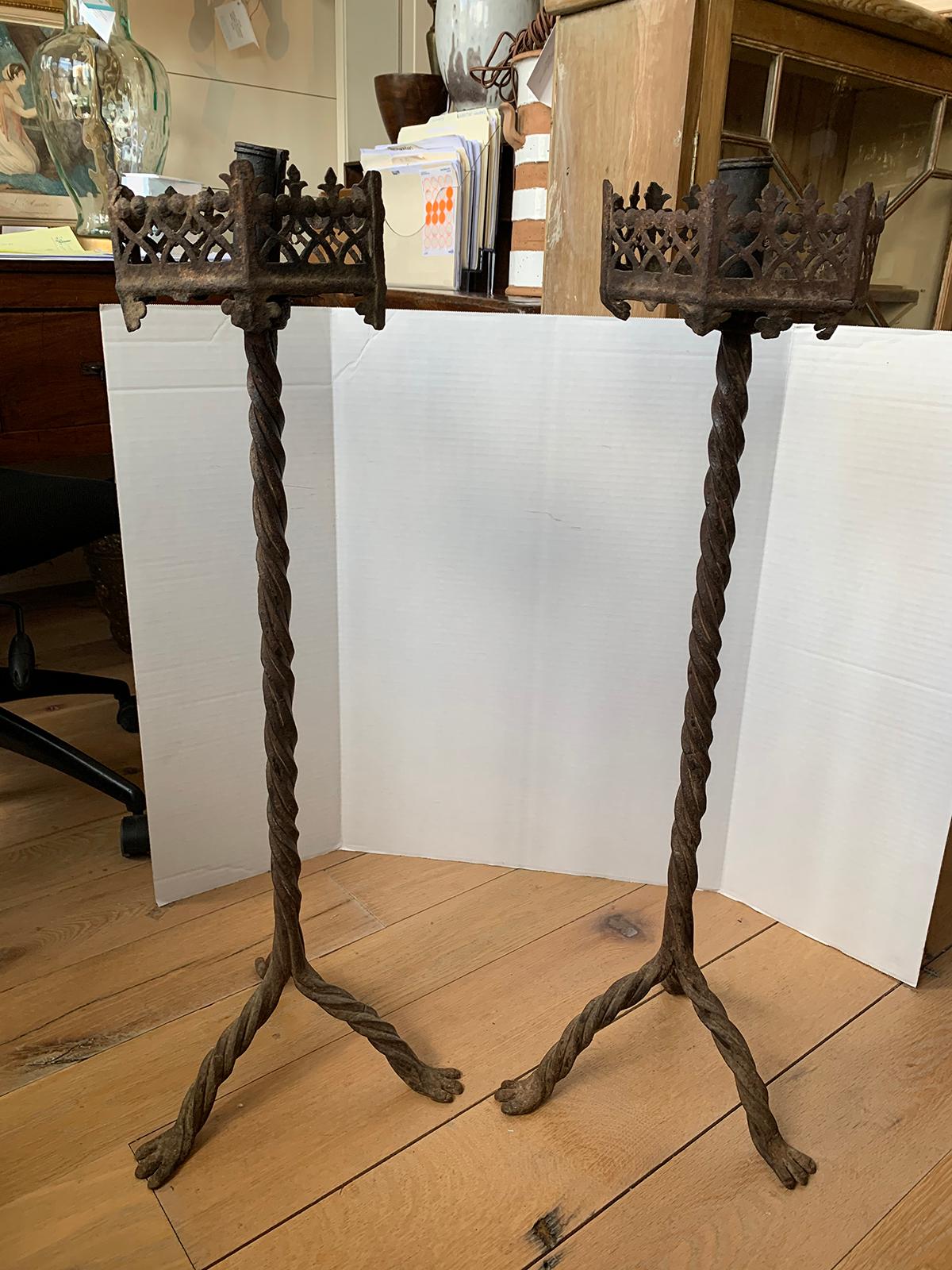 Large scale pair of 19th century continental iron prickets with candlesticks.