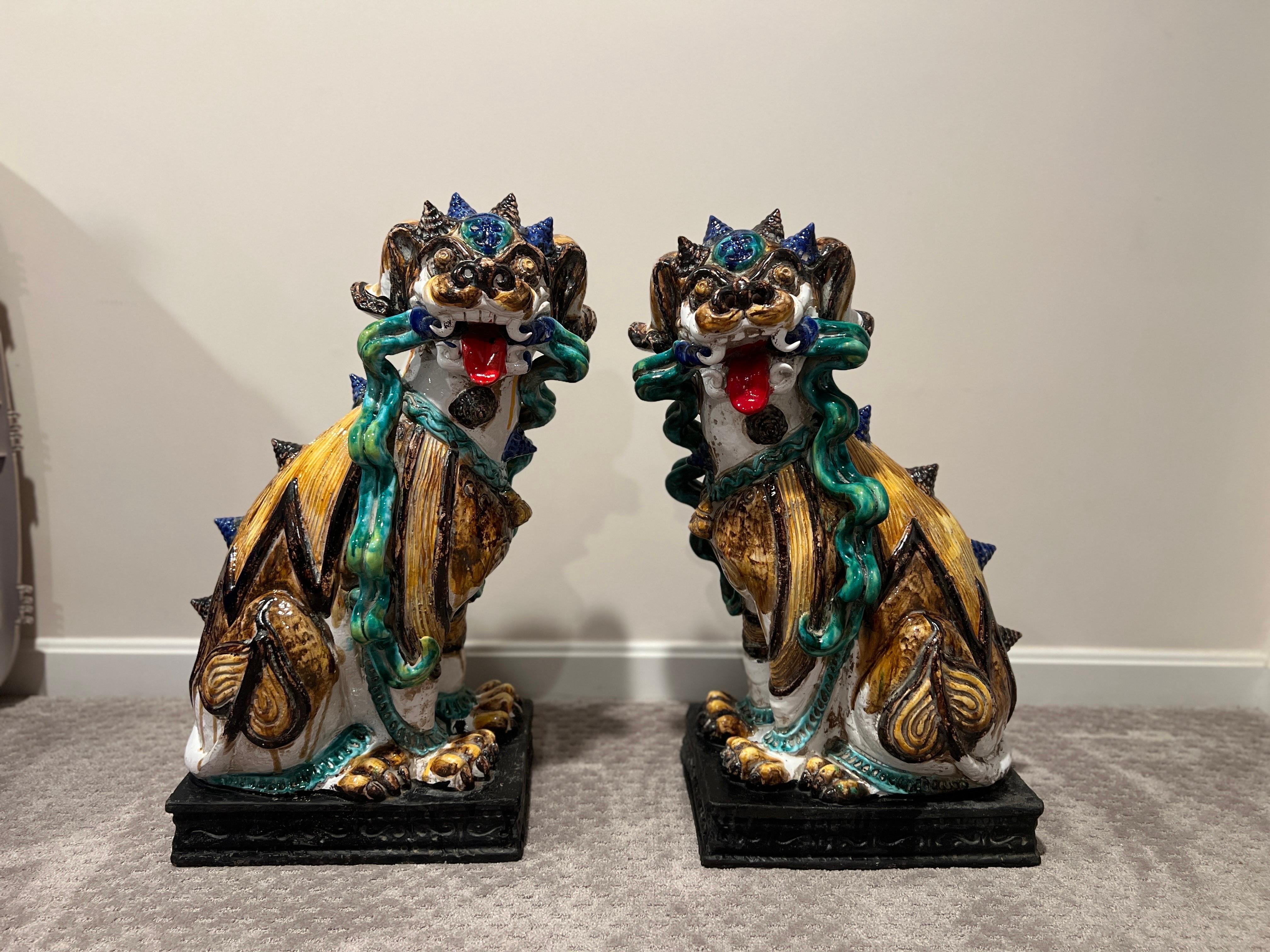 Large Scale Pair of Antique Majolica Ceramic Glazed Guardian Lions or Foo Dogs

These oversized Italian Majolica foo dogs showcase grotesque yet loveably cute features from their twisted fangs, snail shell horns, whispering hair and intricately done