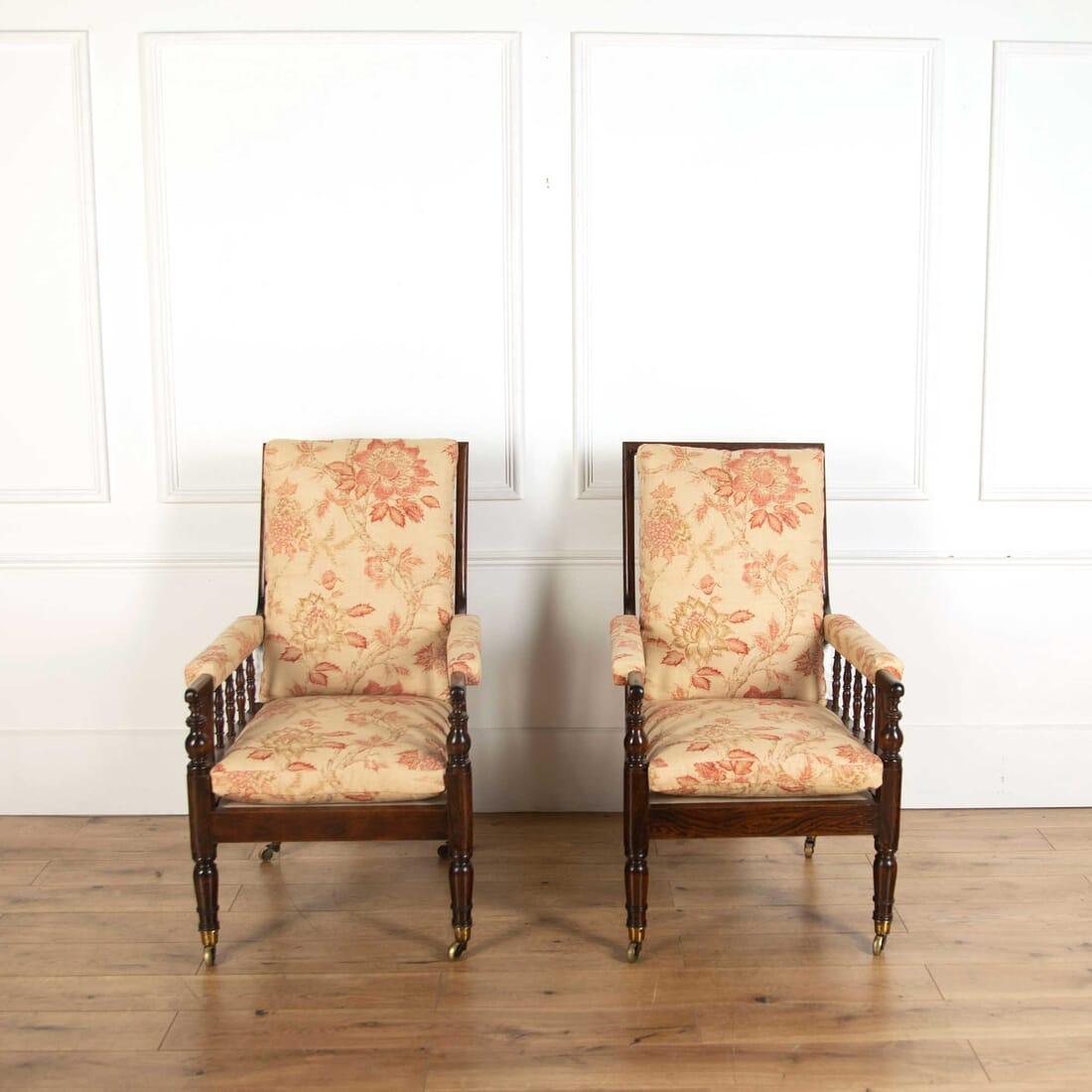 A handsome and large scale pair of Regency simulated rosewood library armchairs.