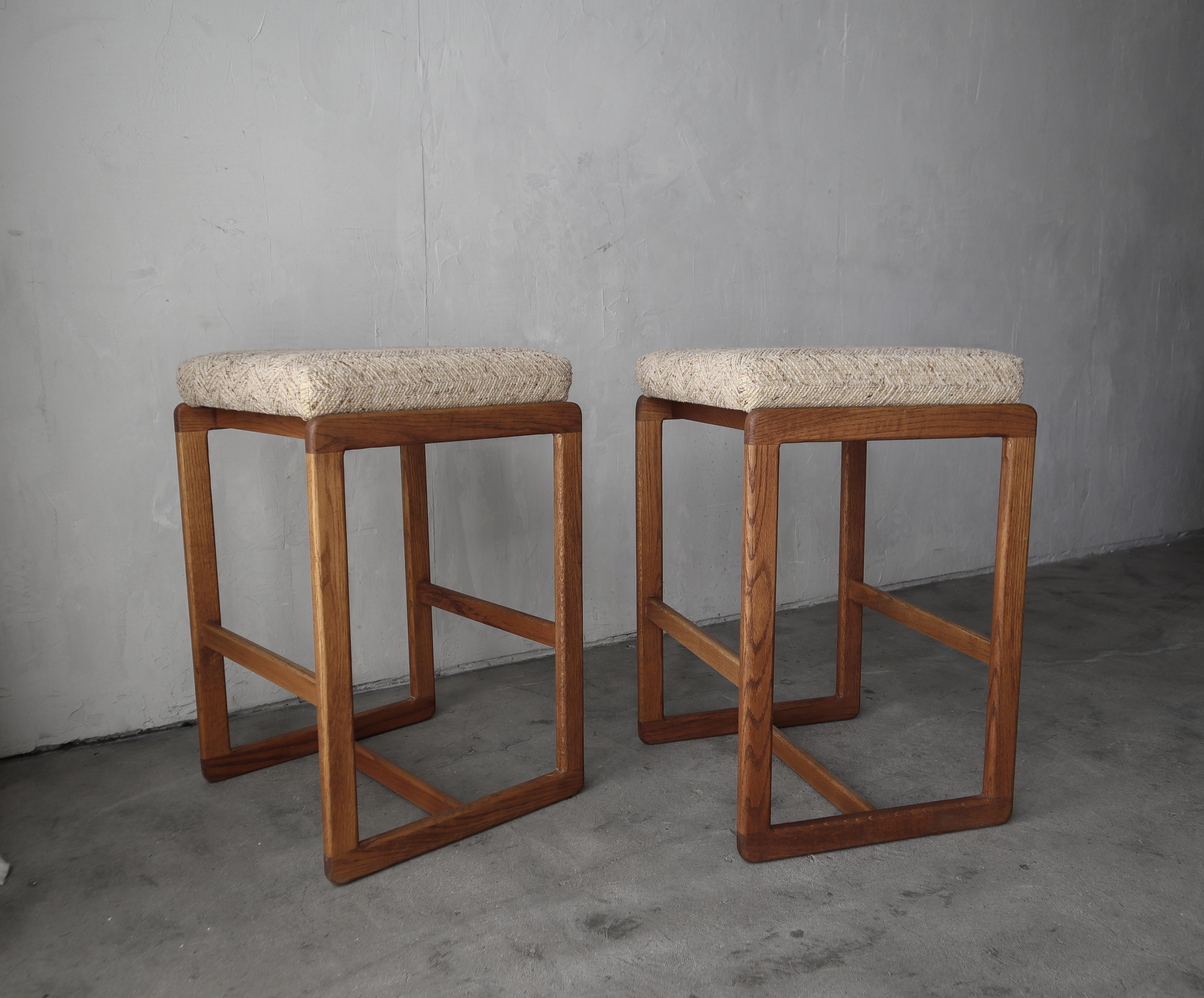 Great pair of vintage, oversized, oak barstools. Love their curved edges.

Solid, no damage.  Fabric is all original, can be used as is but ready for you to modernize and customize if you choose.