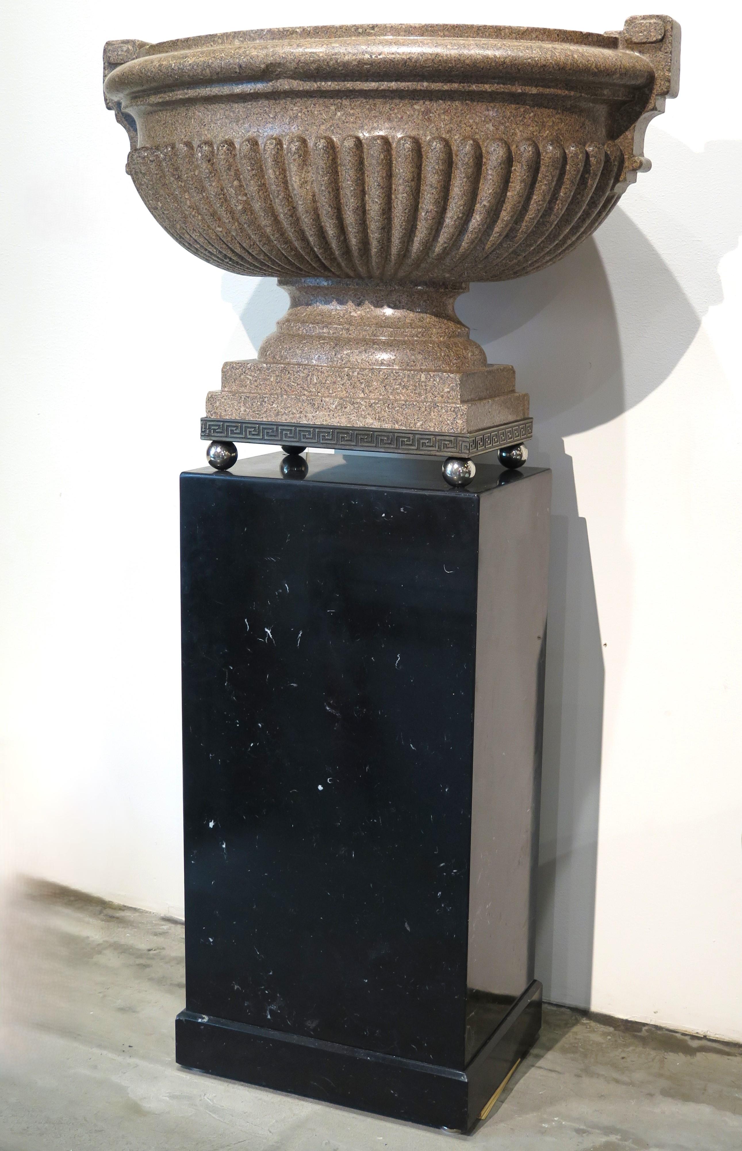 large scale pink granite urn-form jardiniere, 19th century France, mounted on a custom nickel plated base with Greek Key detail and ball feet on a custom made black marble plinth, France. circa 1780. 

from a quarry between Brittany and Cherbourg in